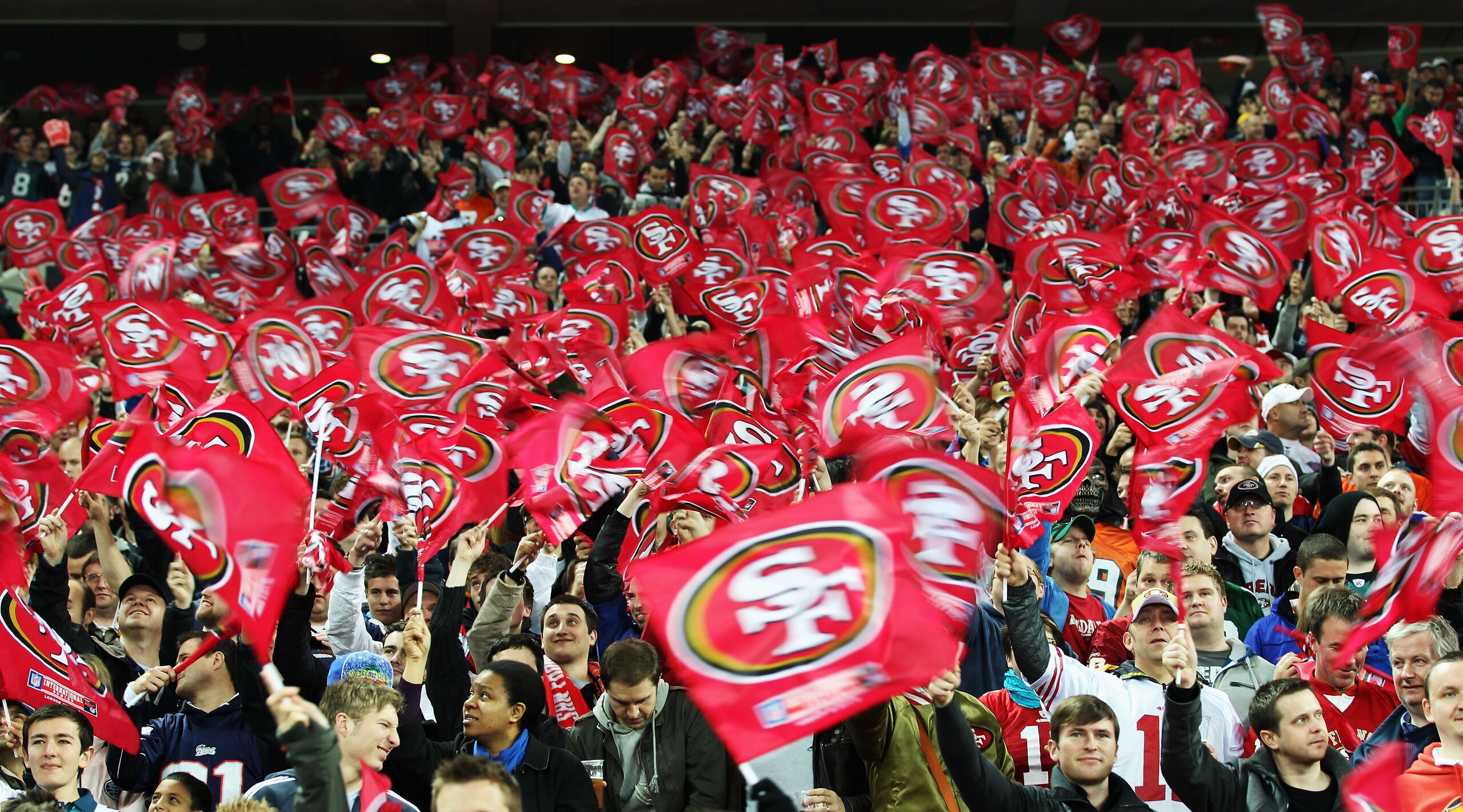 LONDON, ENGLAND - OCTOBER 31:  San Francisco 49ers fans waves flags in support of their team during the NFL International Series match between Denver Broncos and San Francisco 49ers at Wembley Stadium on October 31, 2010 in London, England. This is the fo