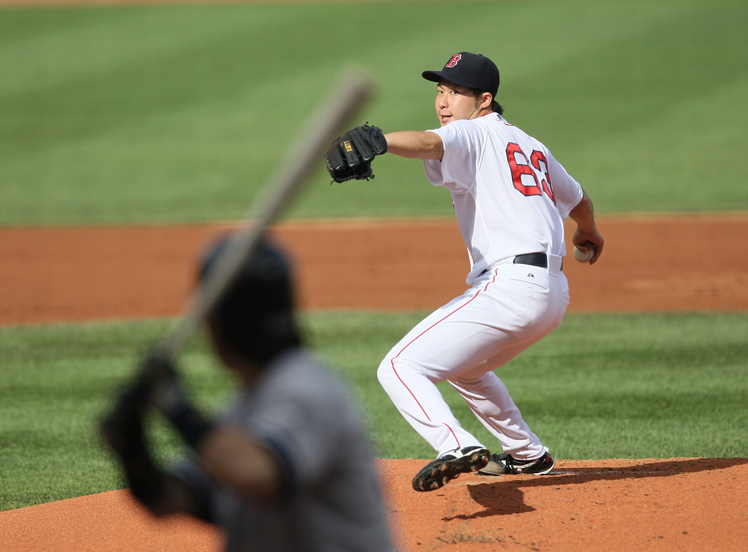 BOSTON - AUGUST 22:  Junichi Tazawa #63 of the Boston Red Sox throws against the New York Yankees at Fenway Park on August 22, 2009 in Boston, Massachusetts. (Photo by Jim Rogash/Getty Images)