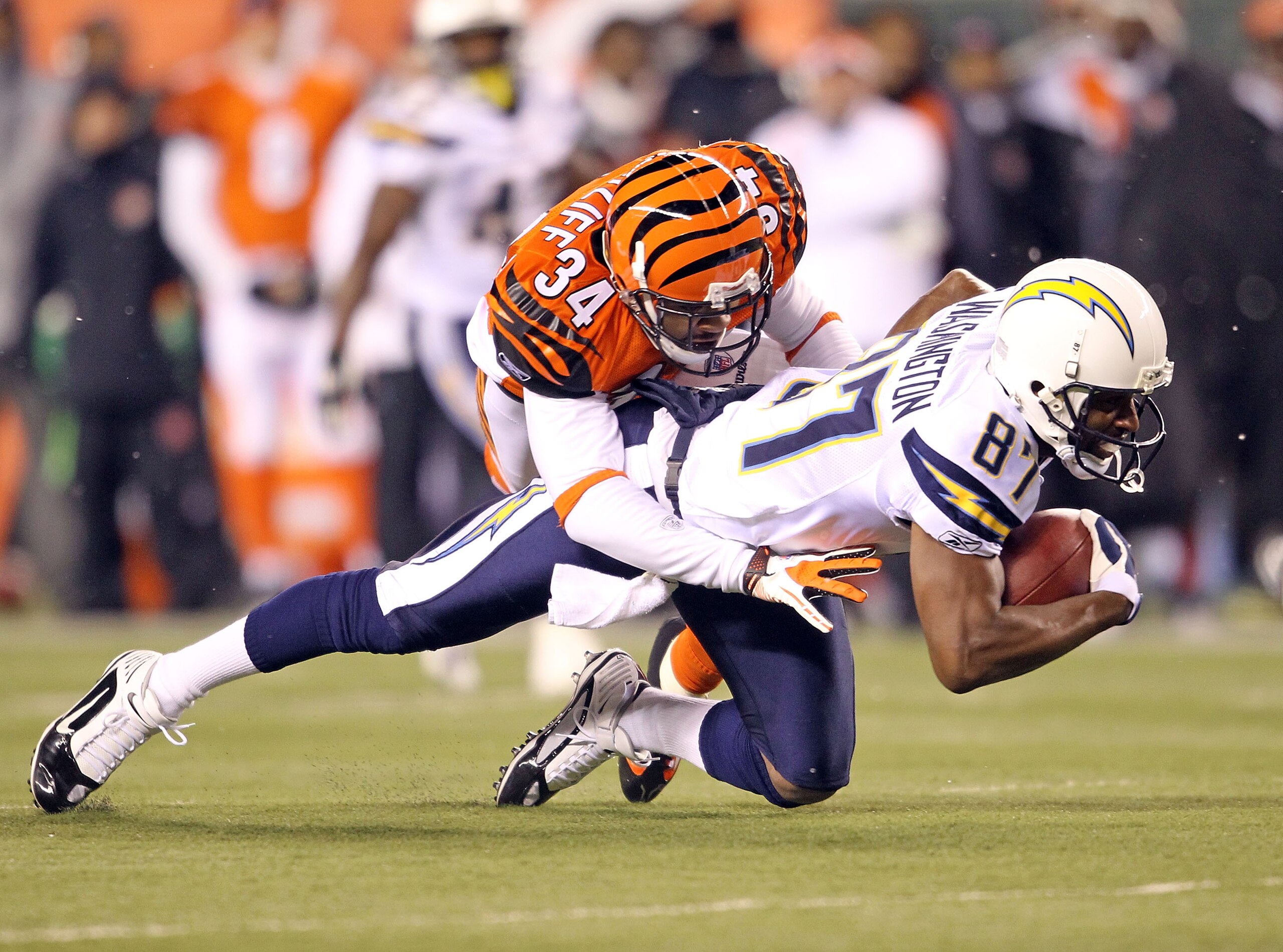 CINCINNATI - DECEMBER 26: Kelley Washington #87  of the San Diego Chargers runs with the ball while defended by Keiwan Ratliff #34 of the Cincinnati Bengals in the NFL game at Paul Brown Stadium on December 26, 2010 in Cincinnati, Ohio.  The Bengals won 3