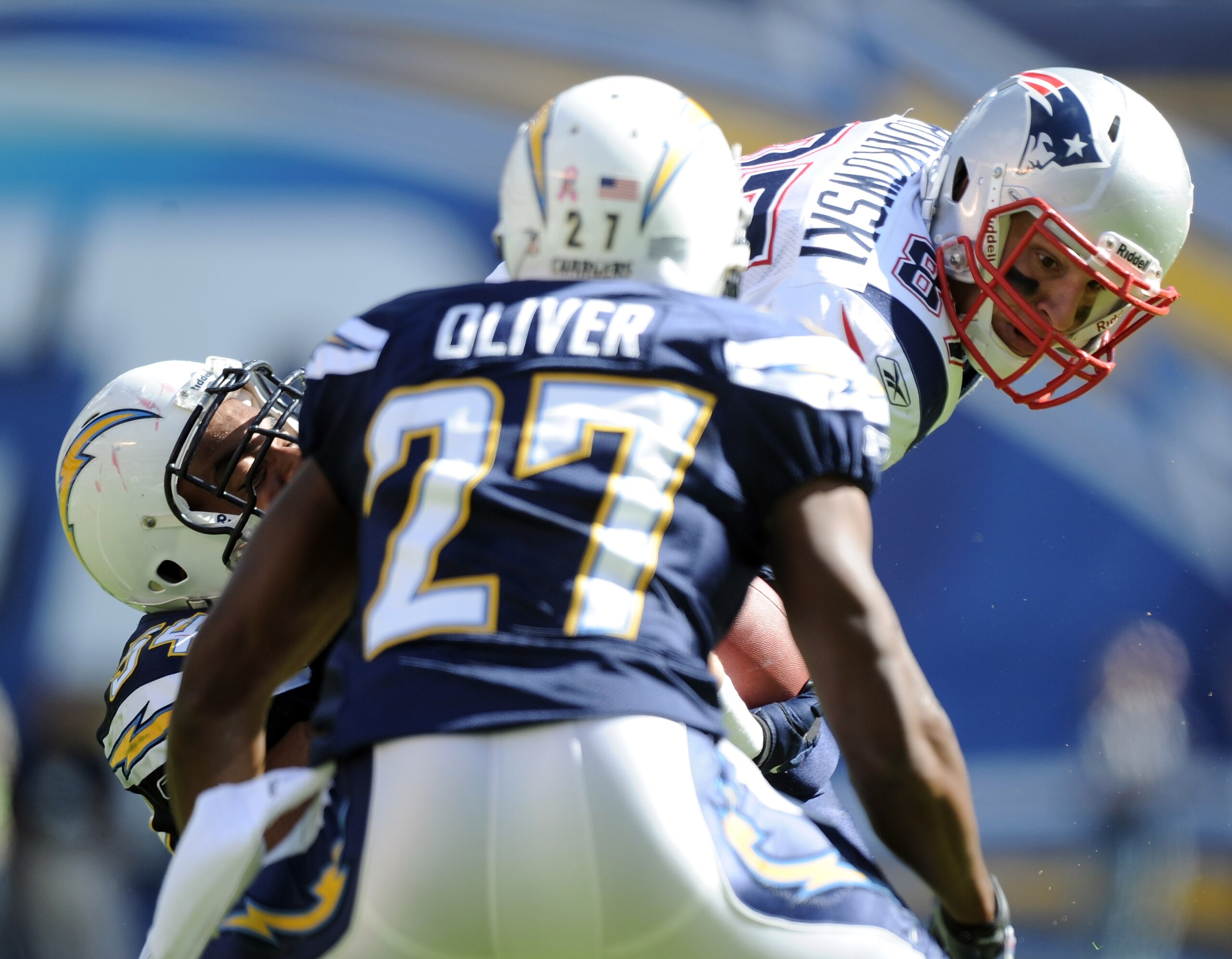 SAN DIEGO - OCTOBER 24:  Rob Gronkowski #87 of the New England Patriots is hit by Stephen Cooper #54 and Paul Oliver #27 of the San Diego Chargers during the first quarter at Qualcomm Stadium on October 24, 2010 in San Diego, California.  (Photo by Harry