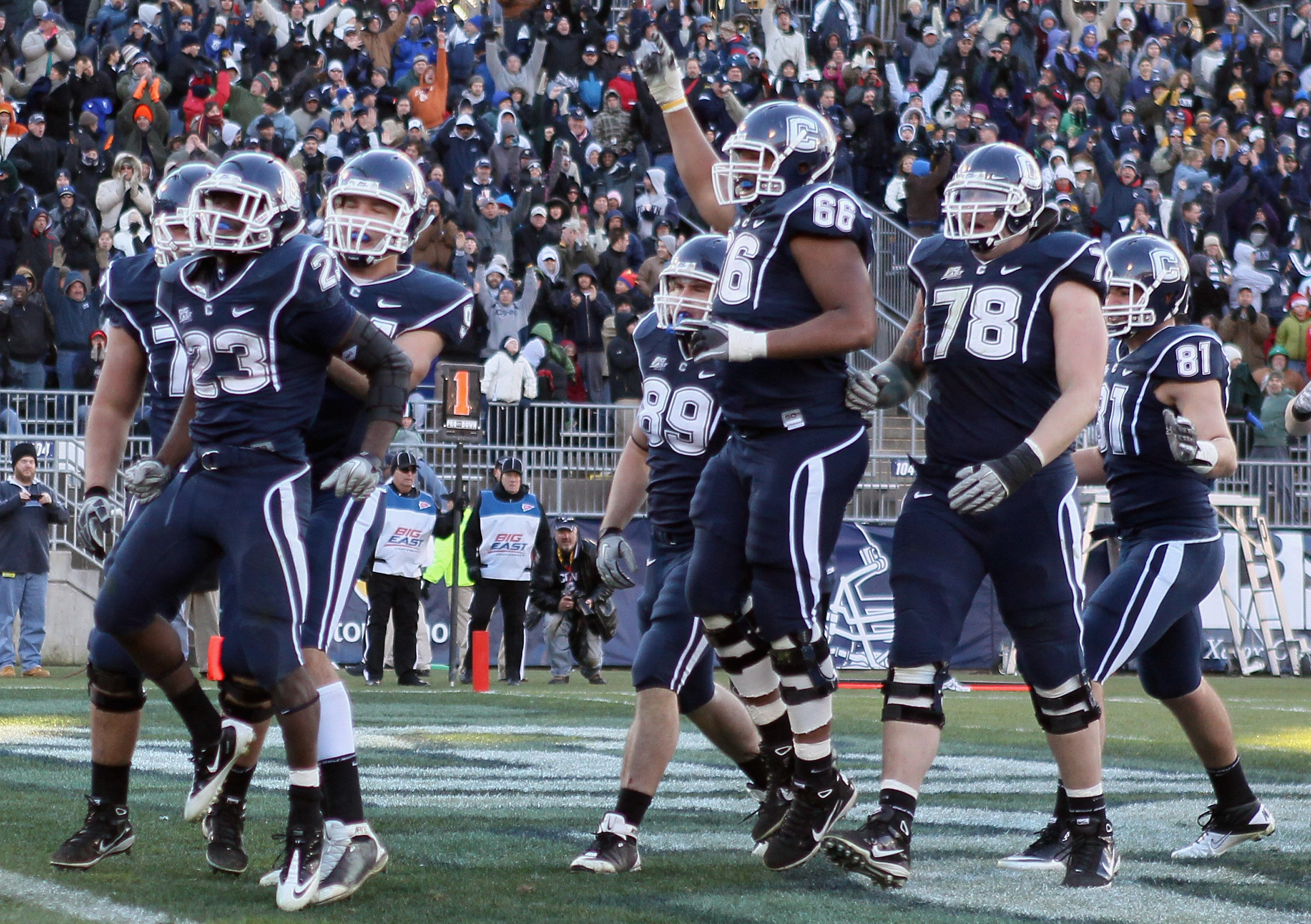 EAST HARTFORD, CT - NOVEMBER 27: Jordan Todman #23 of the Connecticut Huskies celebrates his touchdown with teammates Ryan Griffin #94, Kevin Friend #77 and Mathieu Olivier #66 in the fourth quarter against the Cincinnati Bearcats on November 27, 2010 at
