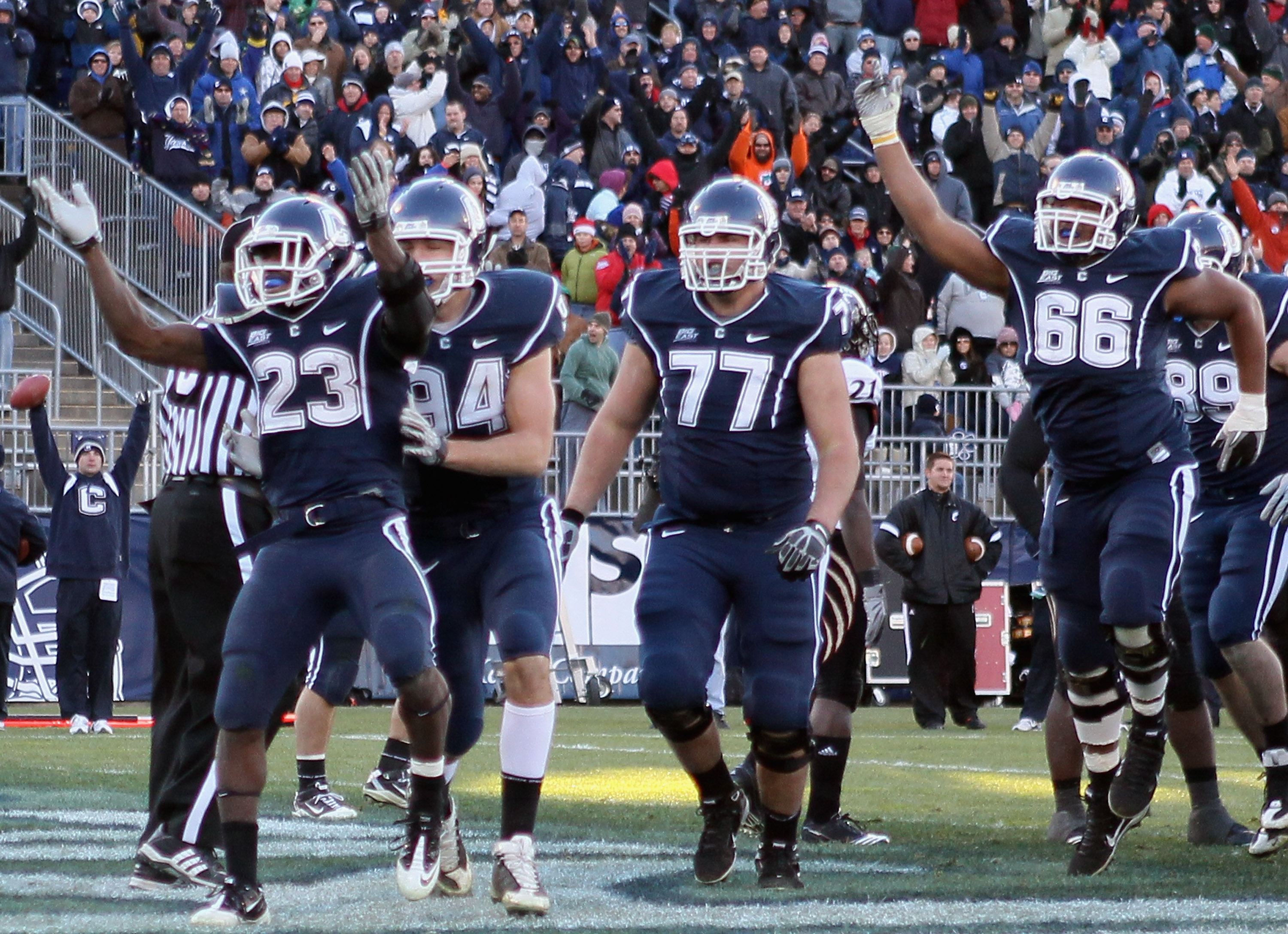 EAST HARTFORD, CT - NOVEMBER 27: Jordan Todman #23 of the Connecticut Huskies celebrates his touchdown with teammates Ryan Griffin #94, Kevin Friend #77 and Mathieu Olivier #66 in the fourth quarter against the Cincinnati Bearcats on November 27, 2010 at