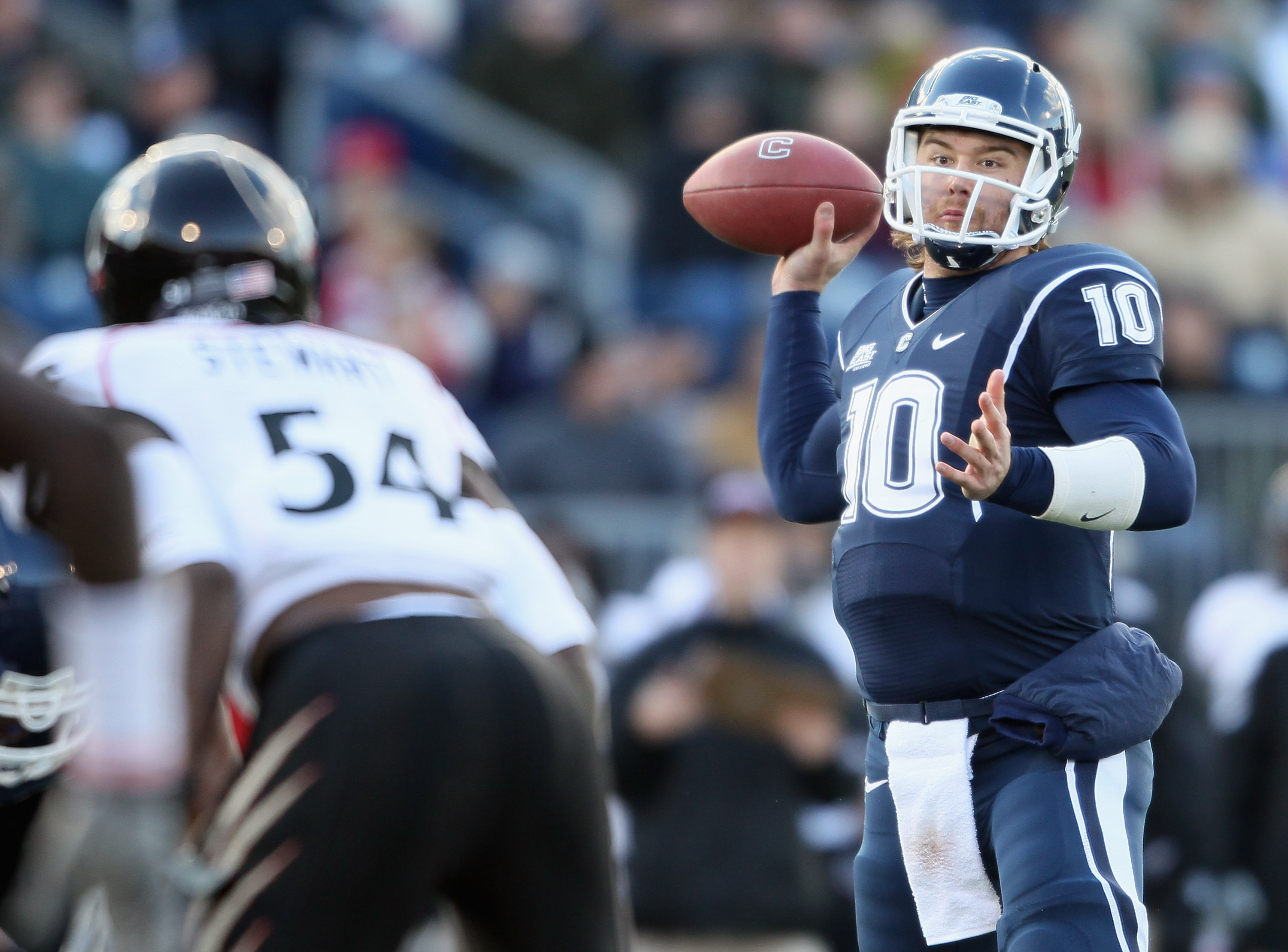 EAST HARTFORD, CT - NOVEMBER 27: Zach Frazer #10 of the Connecticut Huskies looks to pass under pressure from Walter Stewart #54 of the Cincinnati Bearcats on November 27, 2010 at Rentschler Field in East Hartford, Connecticut. (Photo by Elsa/Getty Imag