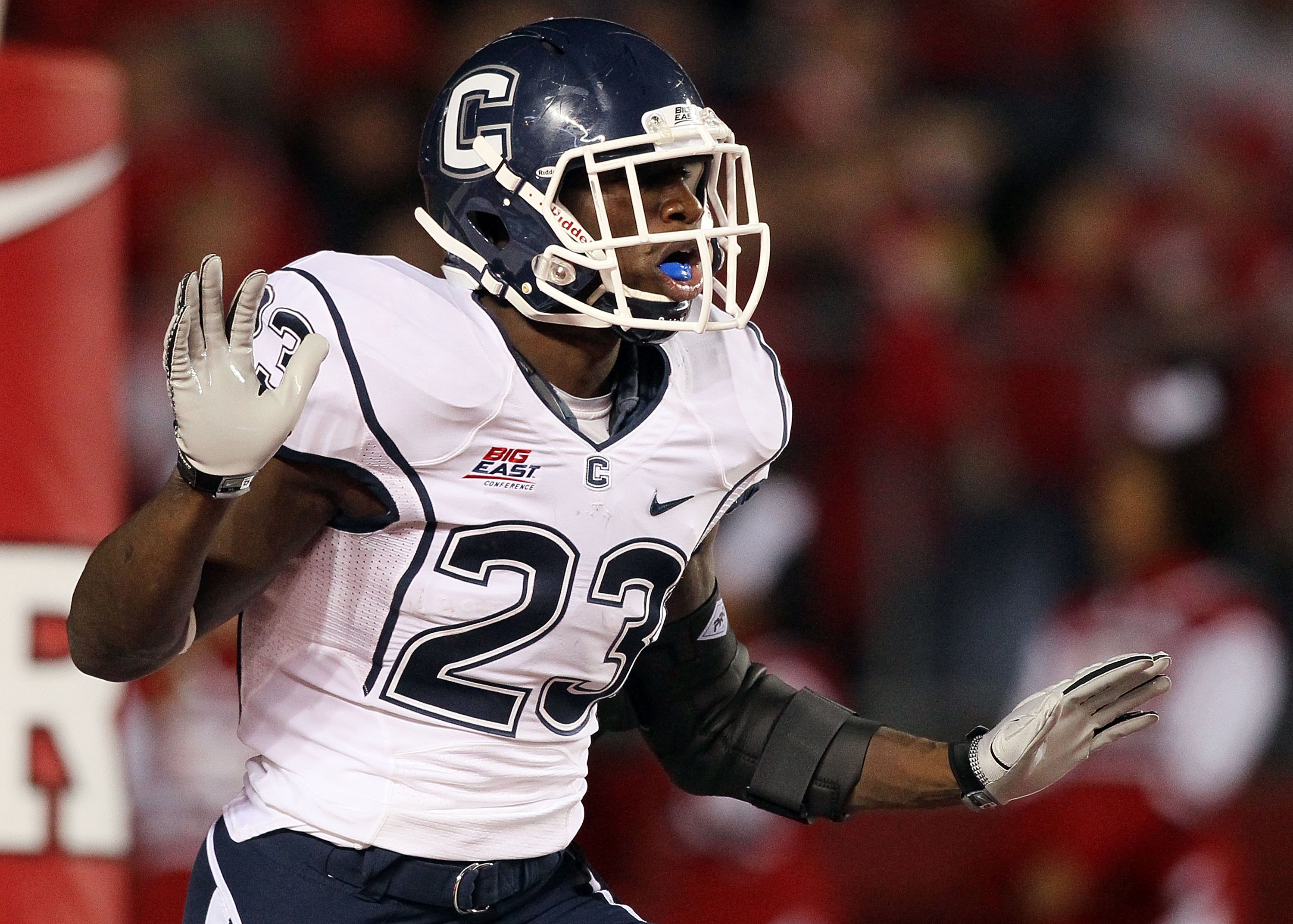 PISCATAWAY, NJ - OCTOBER 08: Jordan Todman #23 of the Connecticut Huskies celebrates his second-quarter touchdown against the Rutgers Scarlet Knights at Rutgers Stadium on October 8, 2010 in Piscataway, New Jersey. (Photo by Jim McIsaac/Getty Images)