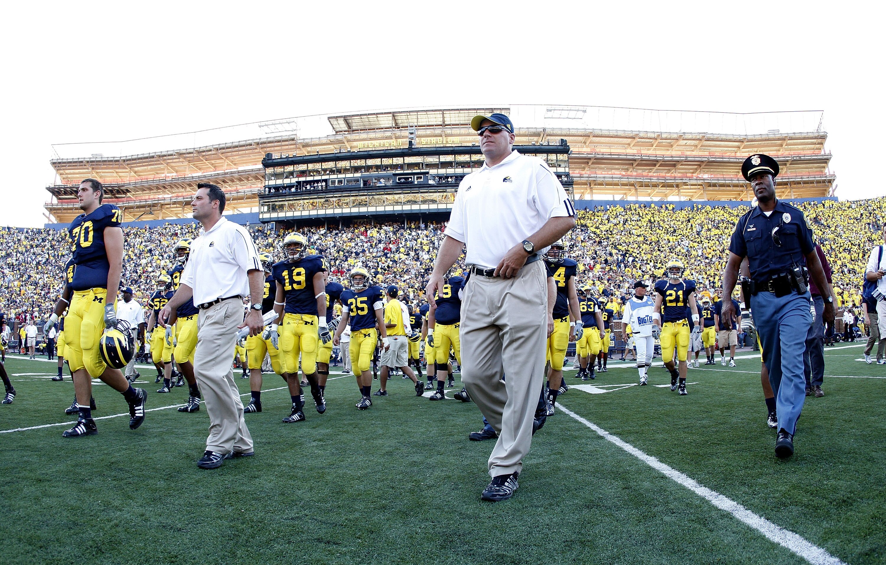 ANN ARBOR, MI - AUGUST 30:  Head coach Rich Rodriguez of the Michigan Wolverines walks of the field in front of Michigan Stadium construction after losing 25-23 to the Utah Utes on August 30, 2008 at Michigan Stadium in Ann Arbor, Michigan.  (Photo by Gre