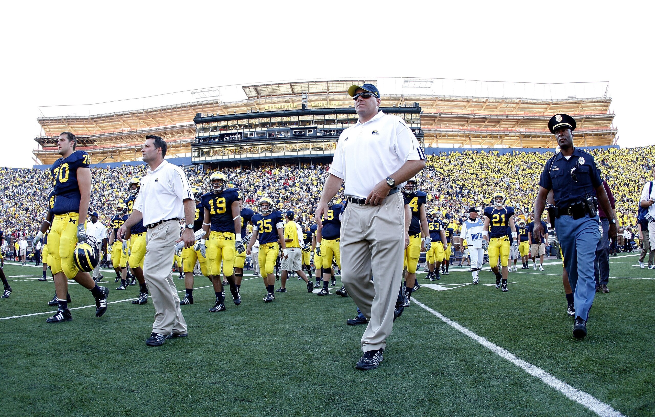ANN ARBOR, MI - AUGUST 30: Head coach Rich Rodriguez of the Michigan Wolverines walks of the field in front of Michigan Stadium construction after losing 25-23 to the Utah Utes on August 30, 2008 at Michigan Stadium in Ann Arbor, Michigan. (Photo by Gre ANN ARBOR, MI - AUGUST 30: Head coach Rich Rodriguez of the Michigan Wolverines walks of the field in front of Michigan Stadium construction after losing 25-23 to the Utah Utes on August 30, 2008 at Michigan Stadium in Ann Arbor, Michigan. (Photo by Gre
