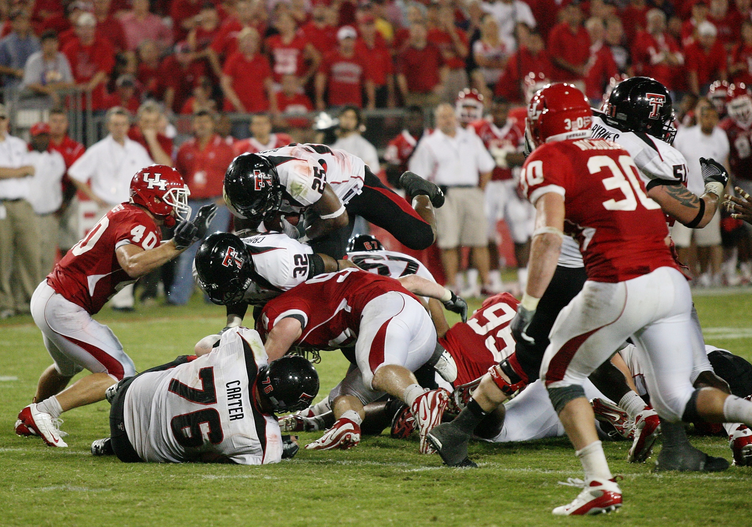 HOUSTON - SEPTEMBER 26:  Running back Baron Batch #25 of the Texas Tech Red Raiders is stopped by the Houston Cougars defense late in the fourth quarter at Robertson Stadium on September 26, 2009 in Houston, Texas.  (Photo by Thomas B. Shea/Getty Images)