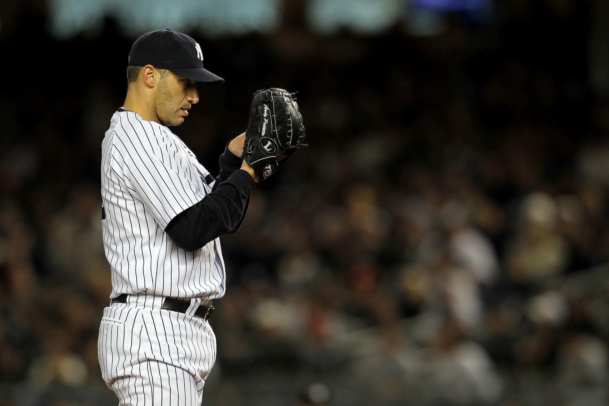 NEW YORK - OCTOBER 18:  Andy Pettitte #46 of the New York Yankees gets set to throw a pitch against the Texas Rangers in Game Three of the ALCS during the 2010 MLB Playoffs at Yankee Stadium on October 18, 2010 in New York, New York.  (Photo by Nick Laham