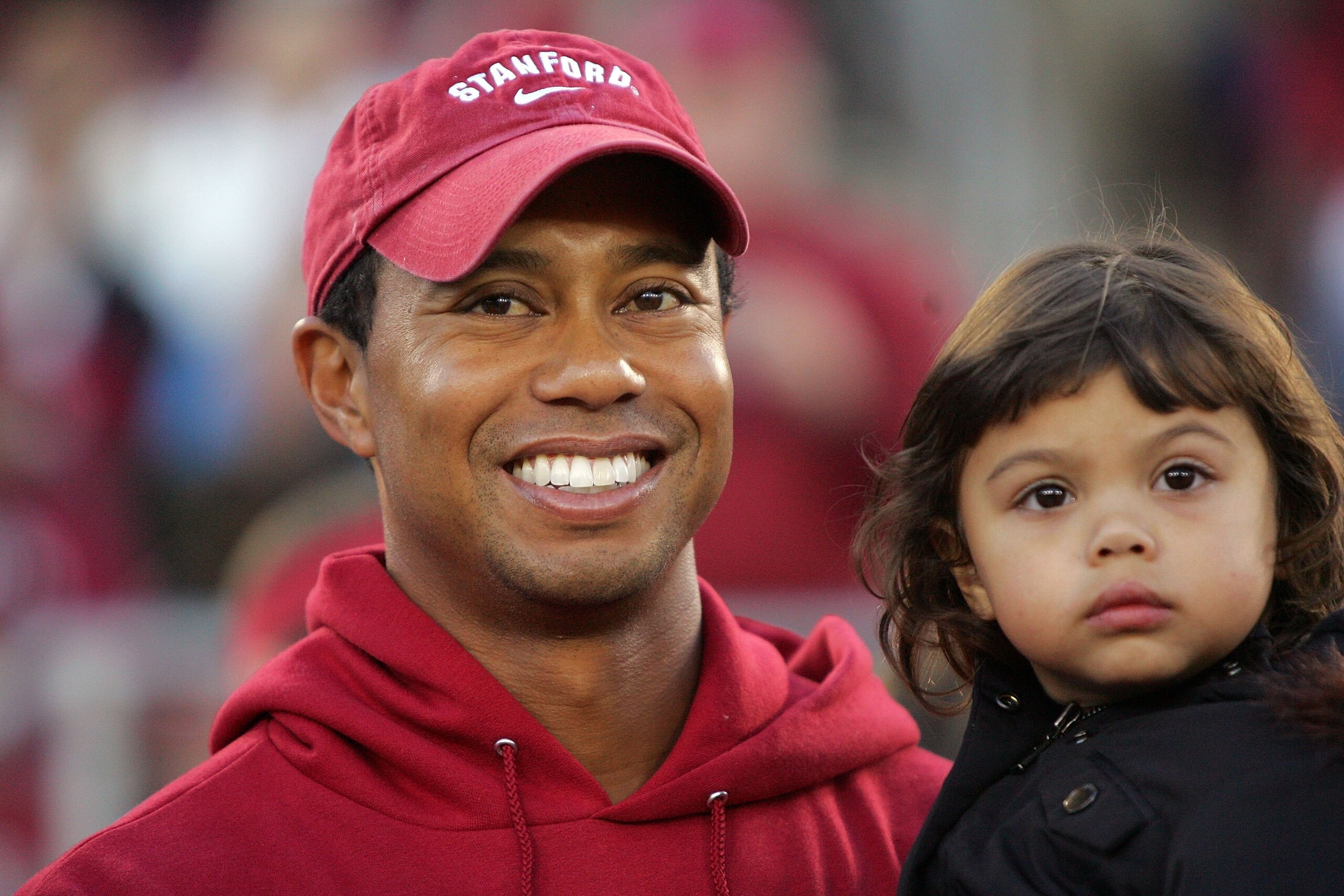 PALO ALTO, CA - NOVEMBER 21:  Honorary Standford Cardinal captain Tiger Woods holds his daugher, Sam, on the sidelines before the Cardinal game against the California Bears at Stanford Stadium on November 21, 2009 in Palo Alto, California.  (Photo by Ezra