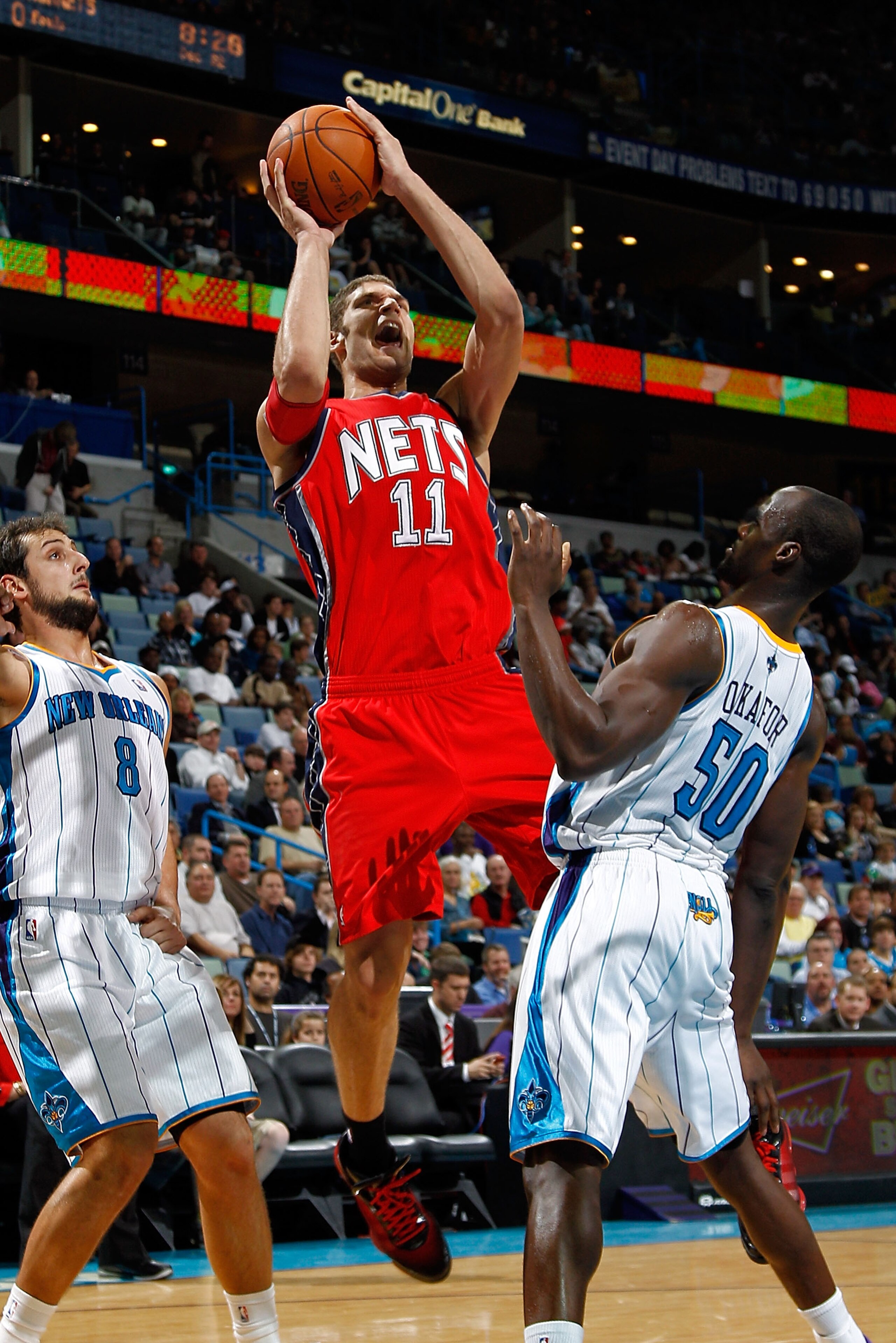NEW ORLEANS, LA - DECEMBER 22:  Brook Lopez #11 of the New Jersey Nets shoots the ball over Emeka Okafor #50 of the New Orleans Hornets at the New Orleans Arena on December 22, 2010 in New Orleans, Louisiana.    The Hornets defeated the Nets 105-91.   NOT