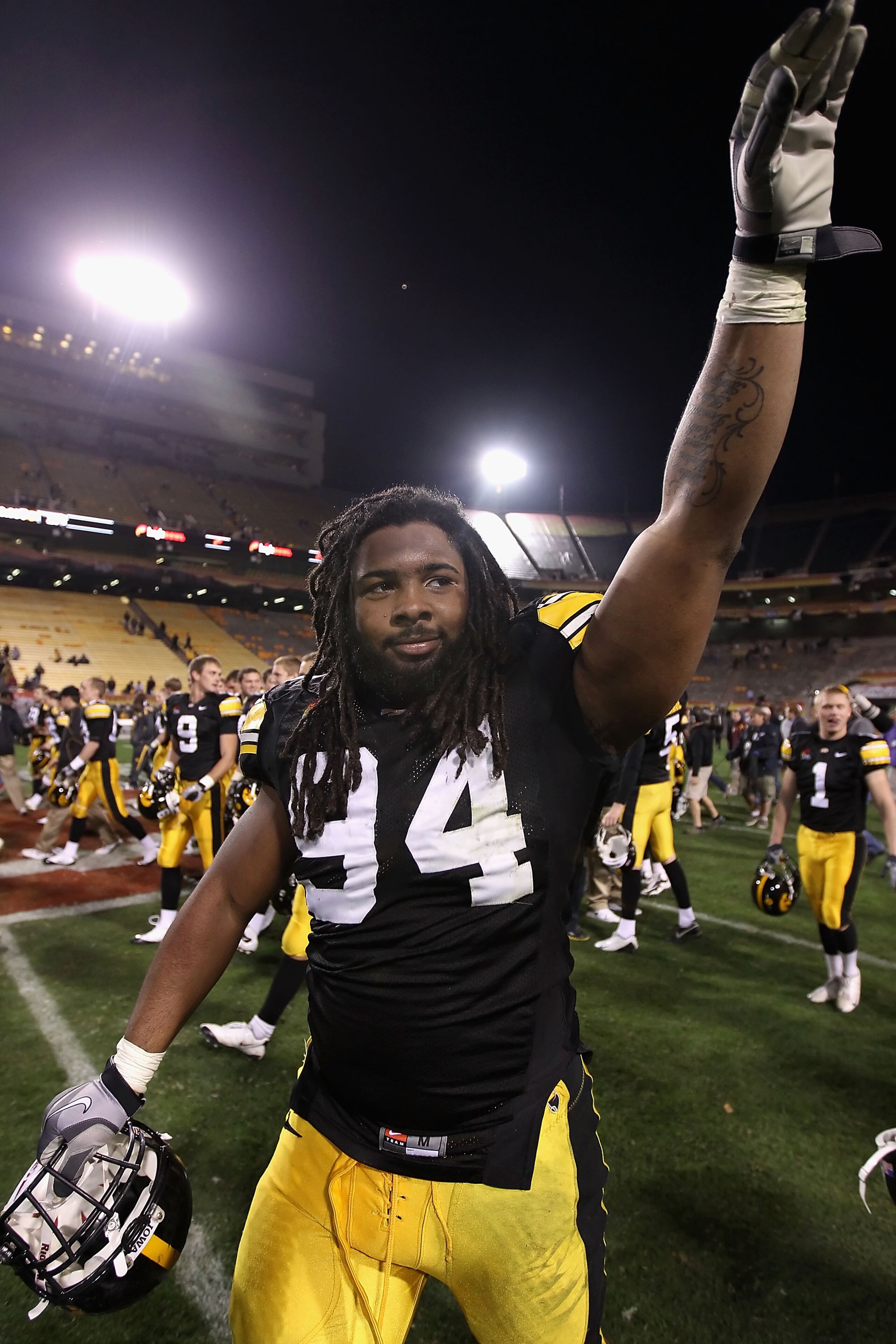 TEMPE, AZ - DECEMBER 28:  Defensive end Adrian Clayborn #94 of the Iowa Hawkeyes waves to fans as he walks off the field after defeating the Missouri Tigers in the Insight Bowl at Sun Devil Stadium on December 28, 2010 in Tempe, Arizona. The Hawkeyes defe