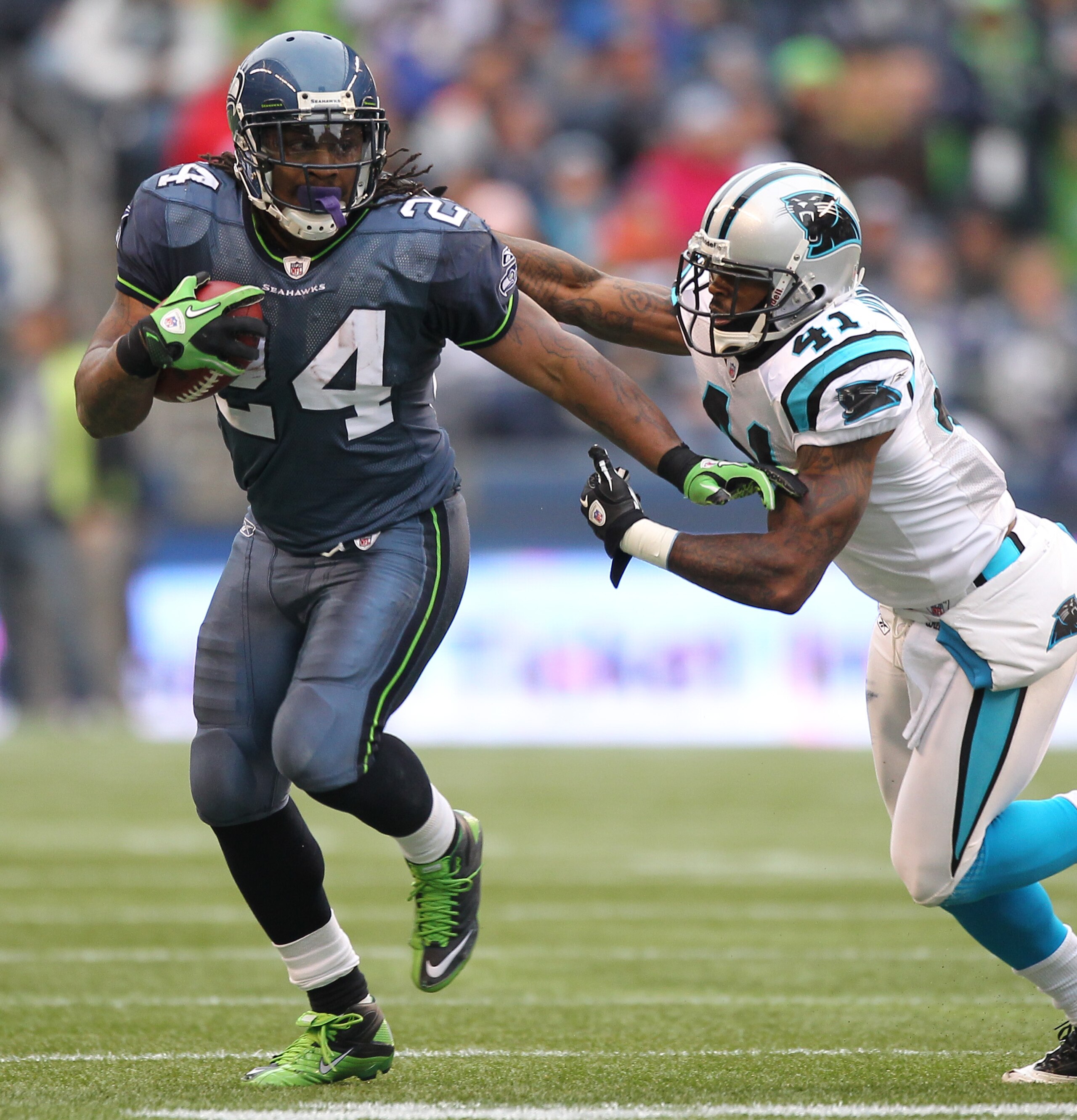SEATTLE - DECEMBER 05:  Running back Marshawn Lynch #24 of the Seattle Seahawks rushes against Captain Munnerlyn #41 of the Carolina Panthers at Qwest Field on December 5, 2010 in Seattle, Washington. The Seahawks defeated the Panthers 31-14. (Photo by Ot
