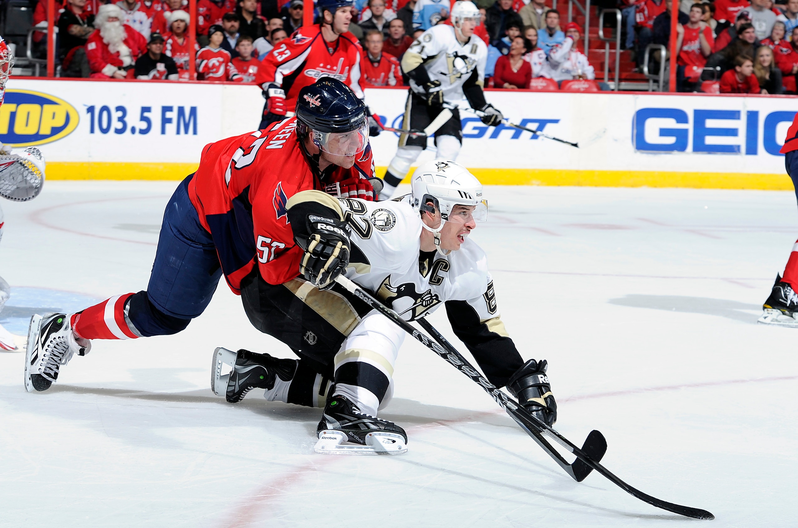 WASHINGTON, DC - DECEMBER 23:  Mike Green #52 of the Washington Capitals battles for position against Sidney Crosby #87 of the Pittsburgh Penguins at the Verizon Center on December 23, 2010 in Washington DC.  (Photo by Greg Fiume/Getty Images)