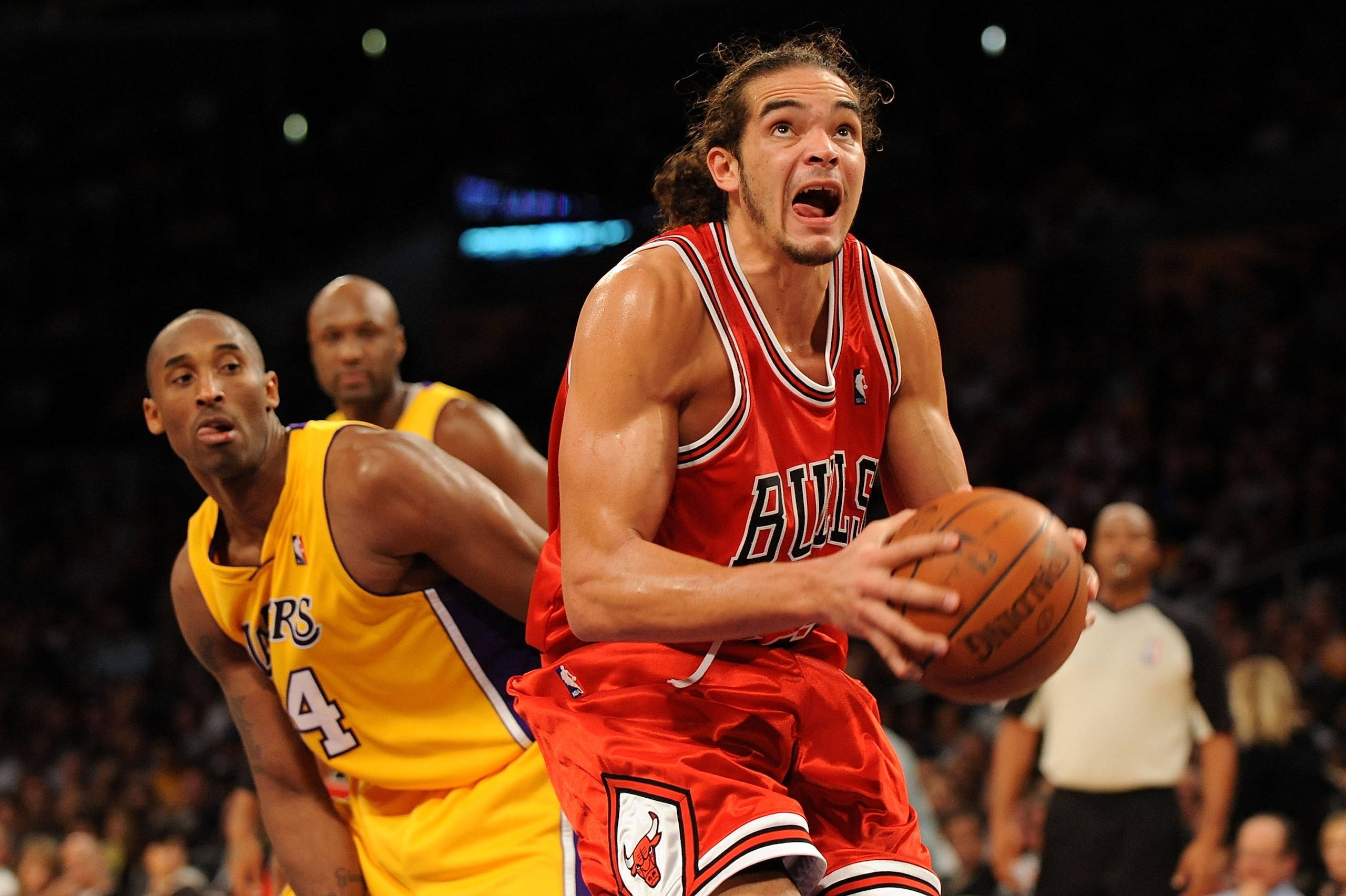 LOS ANGELES, CA - NOVEMBER 19:  Joakim Noah #13 of the Chicago Bulls goes to the basket past Kobe Bryant #24 of the Los Angeles Lakers during the game on November 19, 2009 at Staples Center in Los Angeles, California.  The Lakers won 108-93.  NOTE TO USER