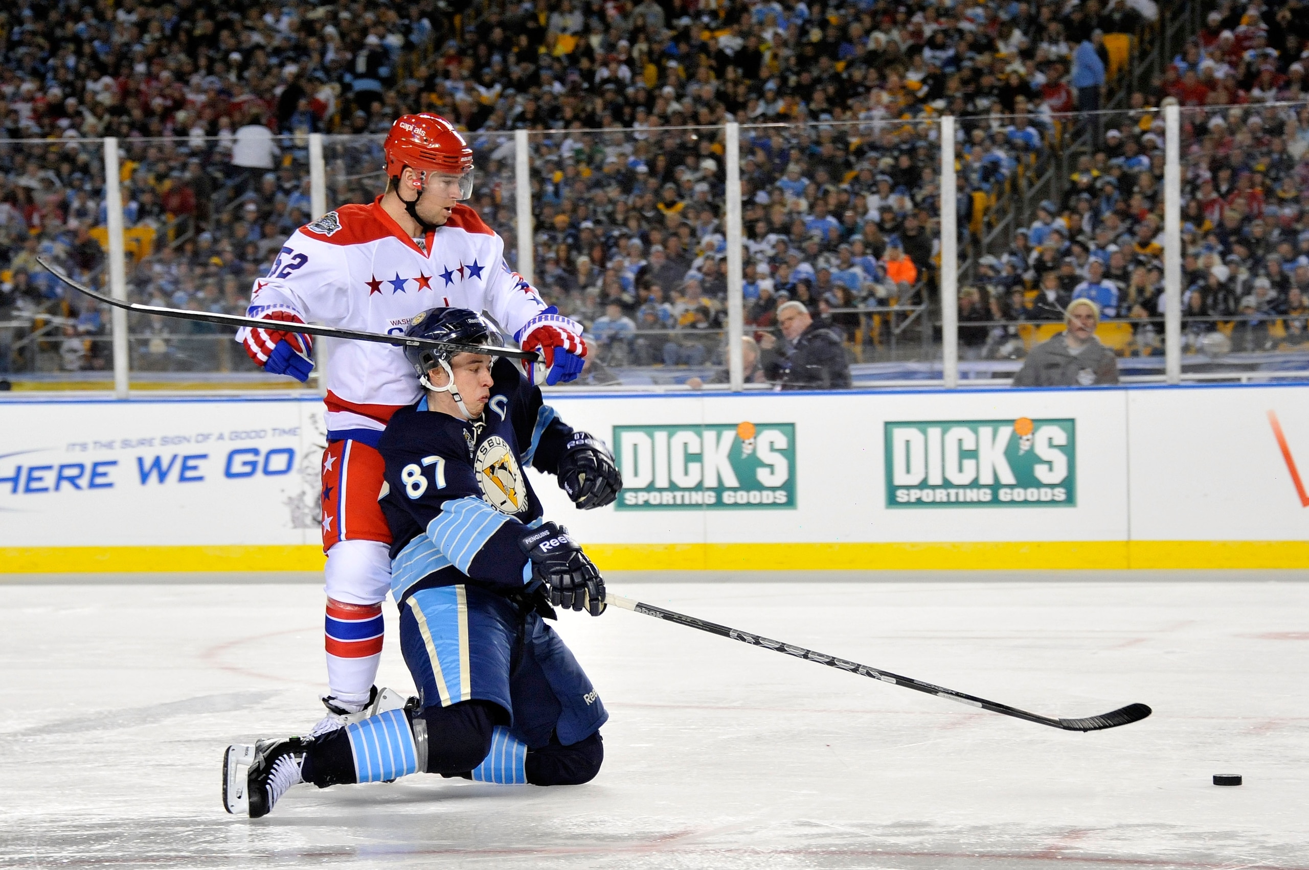 PITTSBURGH, PA - JANUARY 01: Sidney Crosby #87 of the Pittsburgh Penguins battles for the puck against Mike Green #52 of the Washington Capitals during the 2011 NHL Bridgestone Winter Classic at Heinz Field on January 1, 2011 in Pittsburgh, Pennsylvania. PITTSBURGH, PA - JANUARY 01: Sidney Crosby #87 of the Pittsburgh Penguins battles for the puck against Mike Green #52 of the Washington Capitals during the 2011 NHL Bridgestone Winter Classic at Heinz Field on January 1, 2011 in Pittsburgh, Pennsylvania.