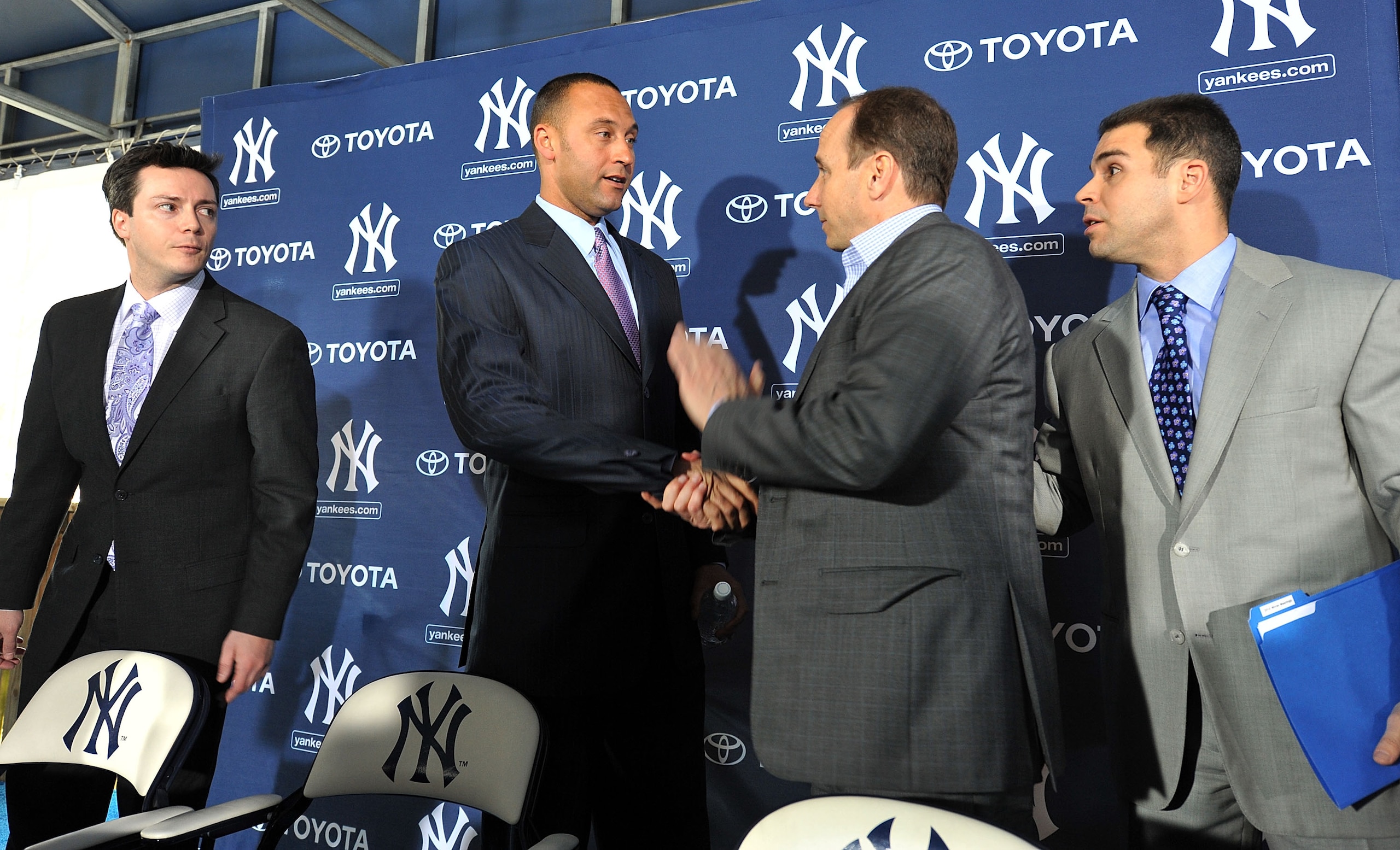 TAMPA, FL - DECEMBER 07:   Shortstop Derek Jeter of the New York Yankees (2L) shakes hands with General Manager Brian Cashman (2R) during a press conference to announce his new contract with the club on December 7, 2010 in Tampa, Florida.  (Photo by Tim B