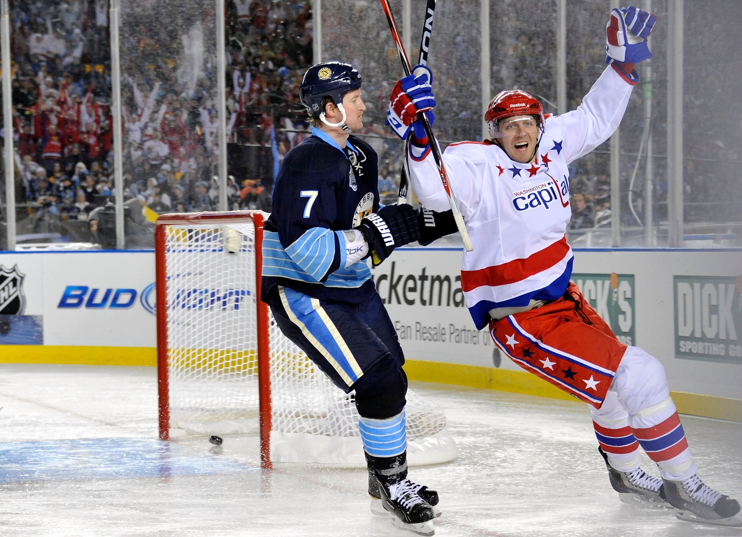 PITTSBURGH, PA - JANUARY 01:  Eric Fehr #16 of the Washington Capitals celebrates scoring in third period as Paul Martin #7 of the Pittsburgh Penguins looks on during the 2011 NHL Bridgestone Winter Classic at Heinz Field on January 1, 2011 in Pittsburgh,