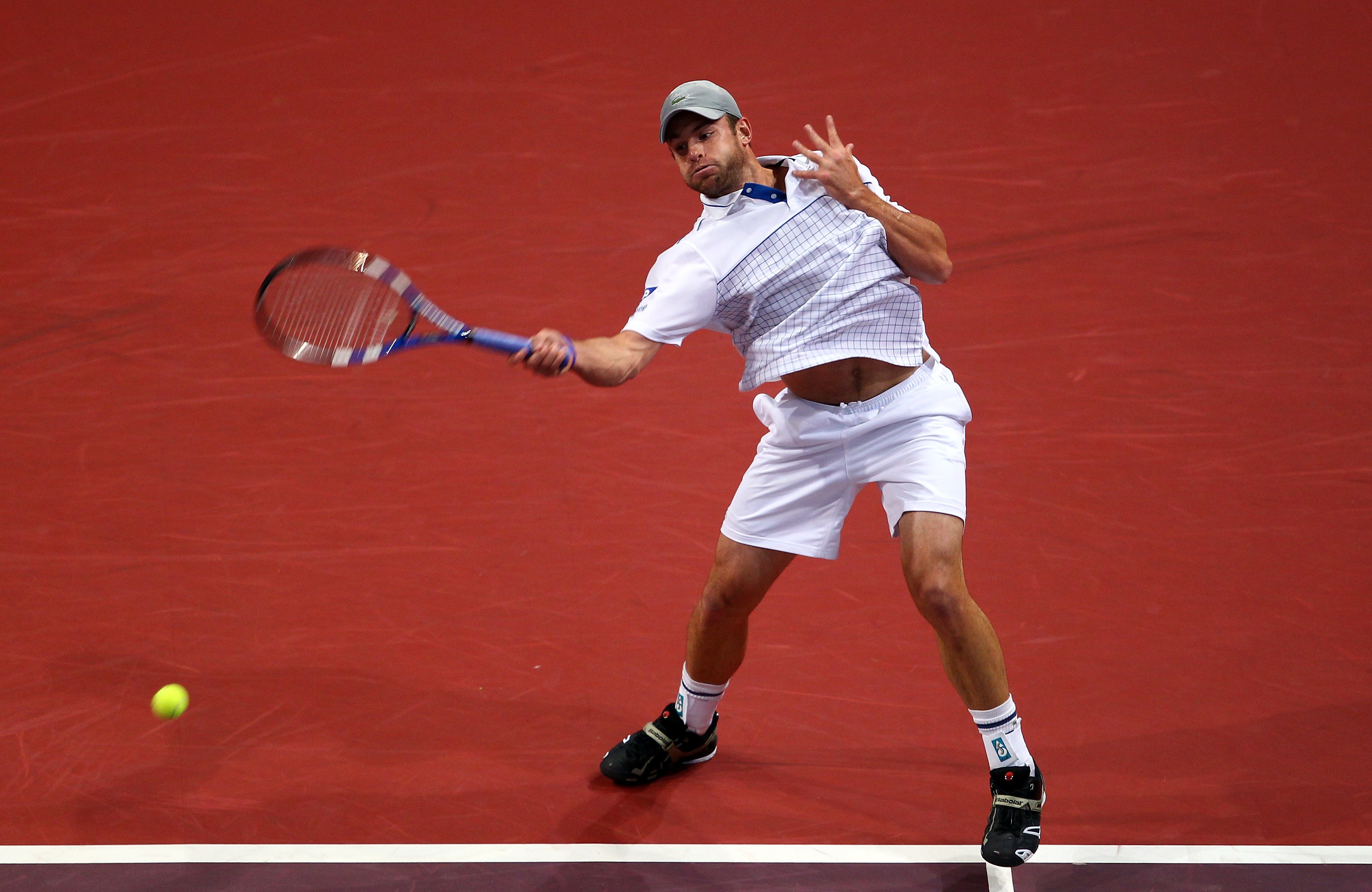 BASEL, SWITZERLAND - NOVEMBER 06:  Andy Roddick of USA plays a forehand in his match against Roger Federer of Switzerland during Day Six of the Davidoff Swiss Indoors Tennis at St Jakobshalle on November 6, 2010 in Basel, Switzerland.  (Photo by Julian Fi