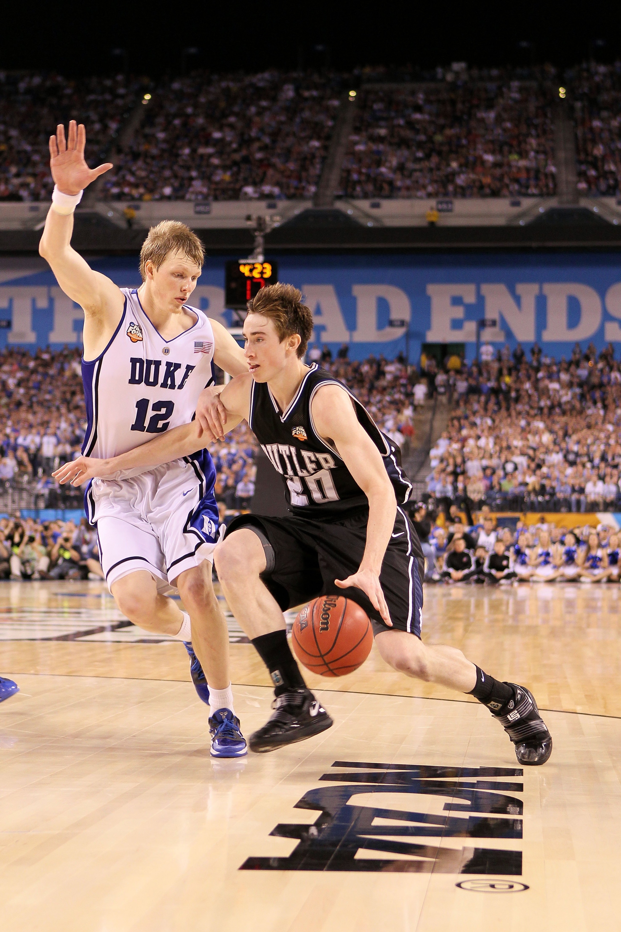 INDIANAPOLIS - APRIL 05:  Gordon Hayward #20 of the Butler Bulldogs drives against Kyle Singler #12 of the Duke Blue Devils during the 2010 NCAA Division I Men's Basketball National Championship game at Lucas Oil Stadium on April 5, 2010 in Indianapolis,