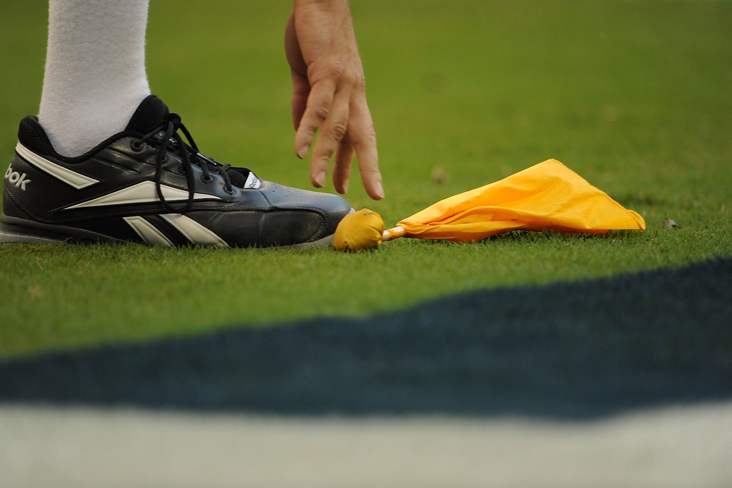 HOUSTON - OCTOBER 19: An NFL official picks up a penalty flag during play between the Detroit Lions and the Houston Texans at Reliant Stadium on October 19, 2008 in Houston, Texas. (Photo by Ronald Martinez/Getty Images) HOUSTON - OCTOBER 19: An NFL official picks up a penalty flag during play between the Detroit Lions and the Houston Texans at Reliant Stadium on October 19, 2008 in Houston, Texas. (Photo by Ronald Martinez/Getty Images)