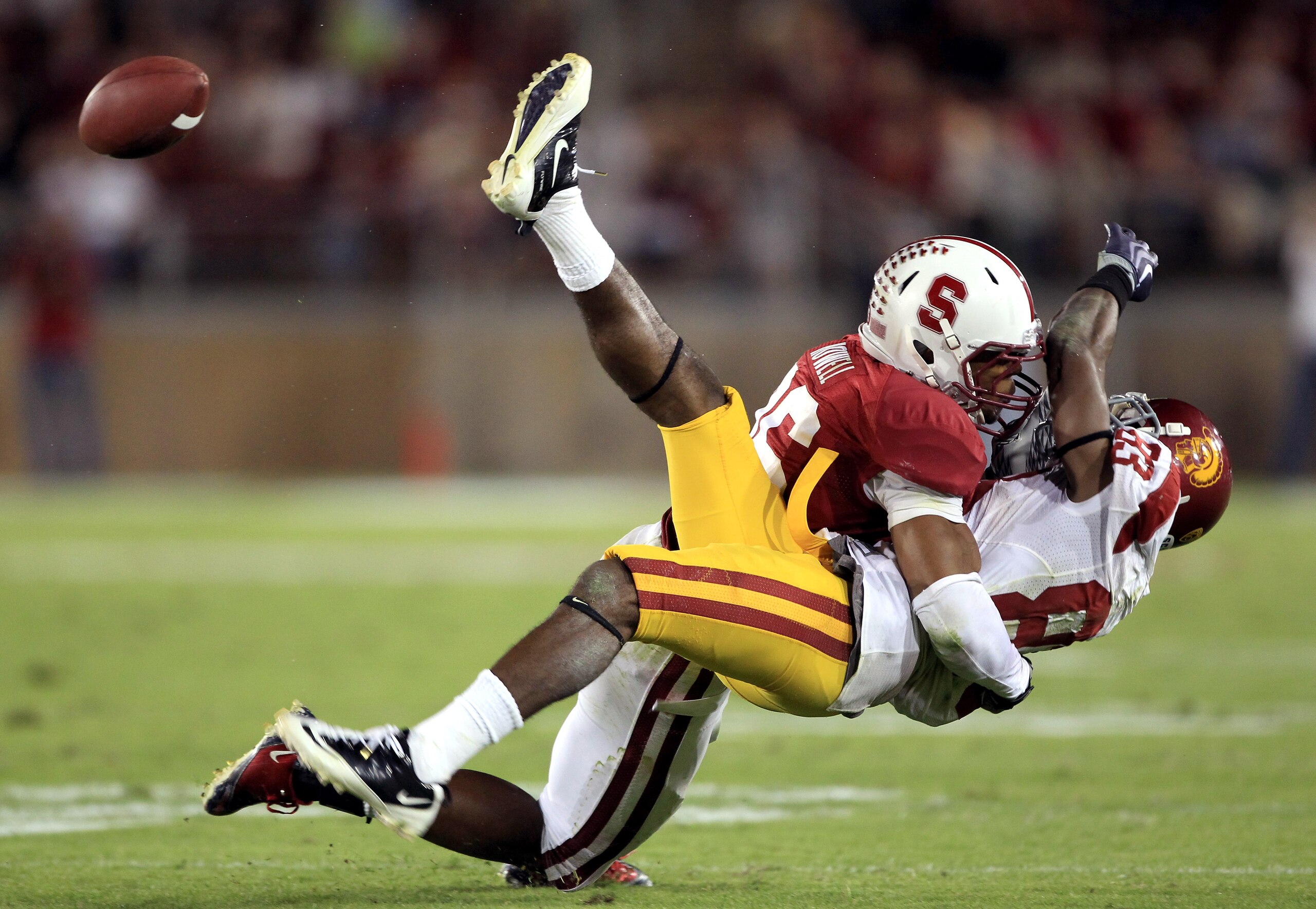 PALO ALTO, CA - OCTOBER 09:  Ronald Johnson #83 of the USC Trojans loses control of the ball when he is hit by Delano Howell #26 of the Stanford Cardinal at Stanford Stadium on October 9, 2010 in Palo Alto, California.  (Photo by Ezra Shaw/Getty Images)