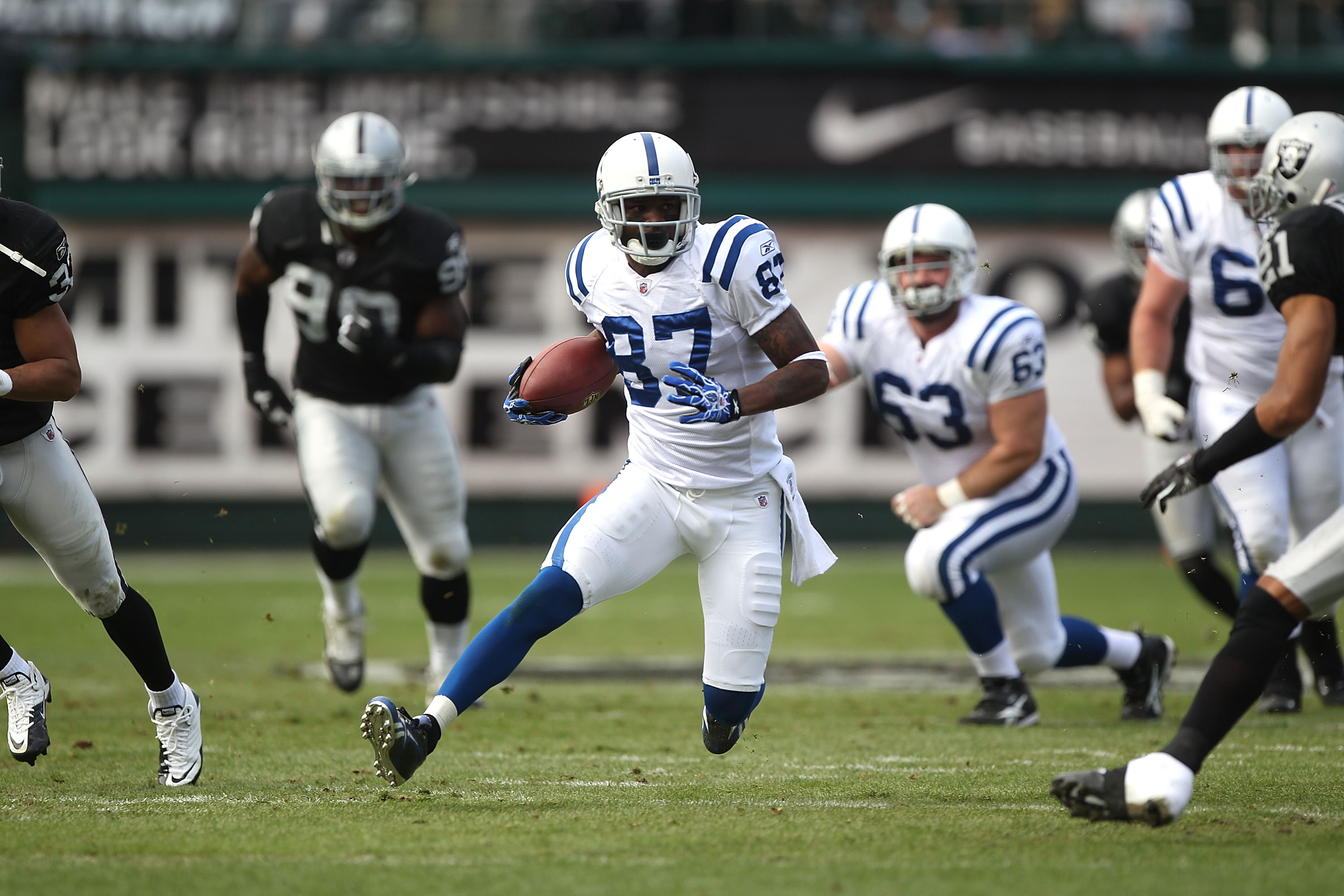 OAKLAND, CA - DECEMBER 26:  Reggie Wayne #87 of the Indianapolis Colts runs after a catch against the Oakland Raiders during an NFL game at Oakland-Alameda County Coliseum on December  26, 2010 in Oakland, California.  (Photo by Jed Jacobsohn/Getty Images