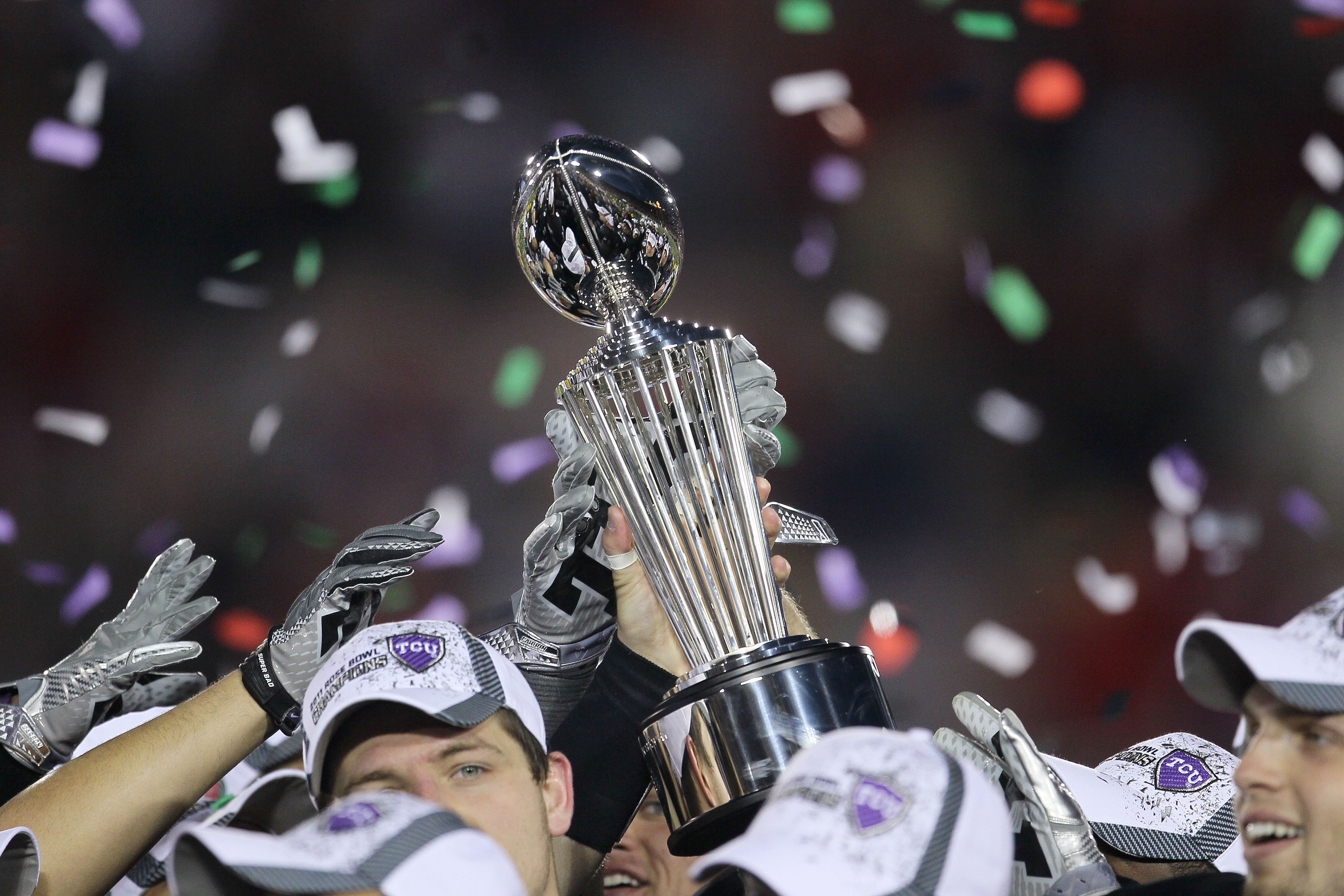PASADENA, CA - JANUARY 01:  The TCU Horned Frogs hold the Rose Bowl Championship Trophy after defeating the Wisconsin Badgers 21-19 in the 97th Rose Bowl game on January 1, 2011 in Pasadena, California.  (Photo by Stephen Dunn/Getty Images)