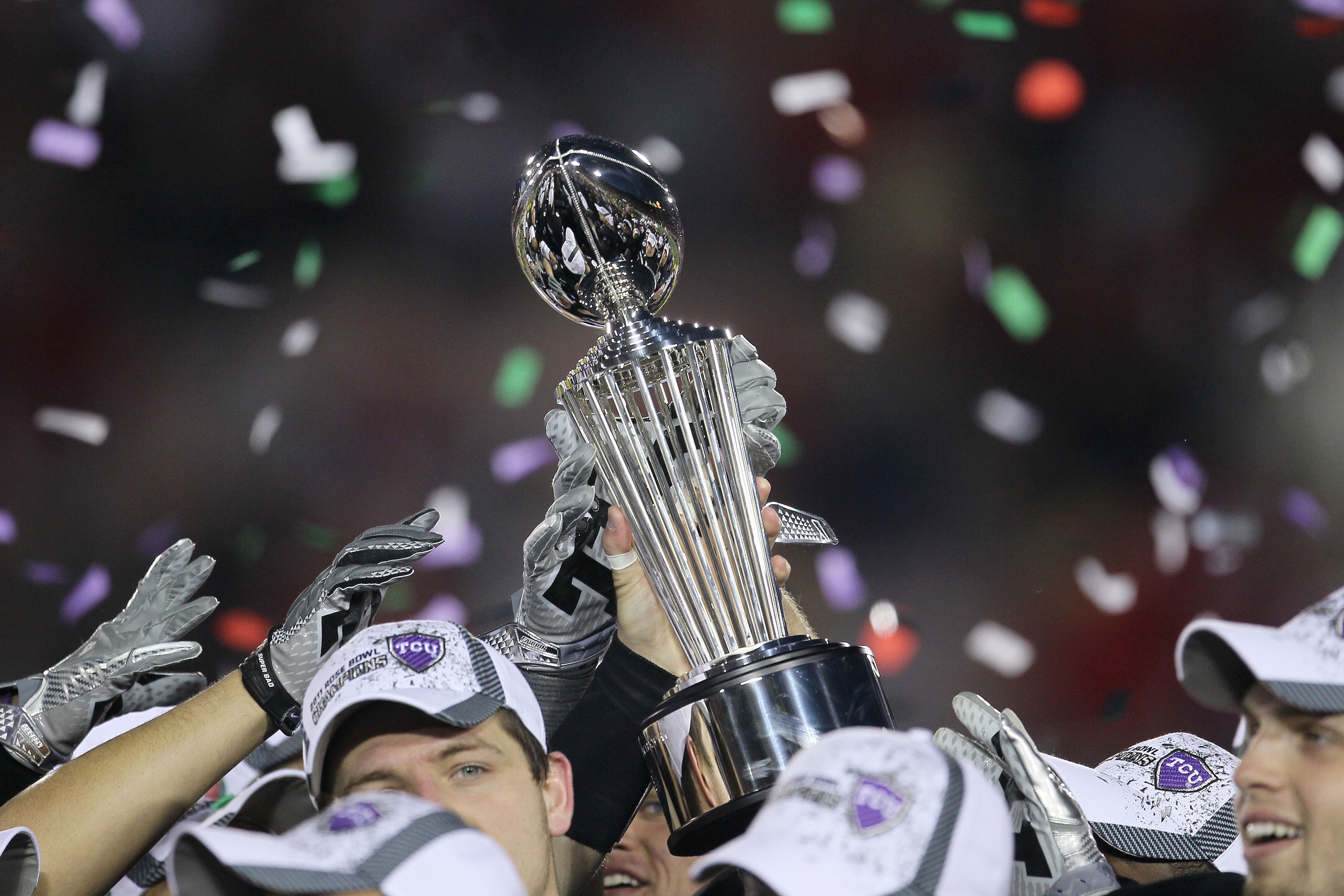 PASADENA, CA - JANUARY 01:  The TCU Horned Frogs hold the Rose Bowl Championship Trophy after defeating the Wisconsin Badgers 21-19 in the 97th Rose Bowl game on January 1, 2011 in Pasadena, California.  (Photo by Stephen Dunn/Getty Images)