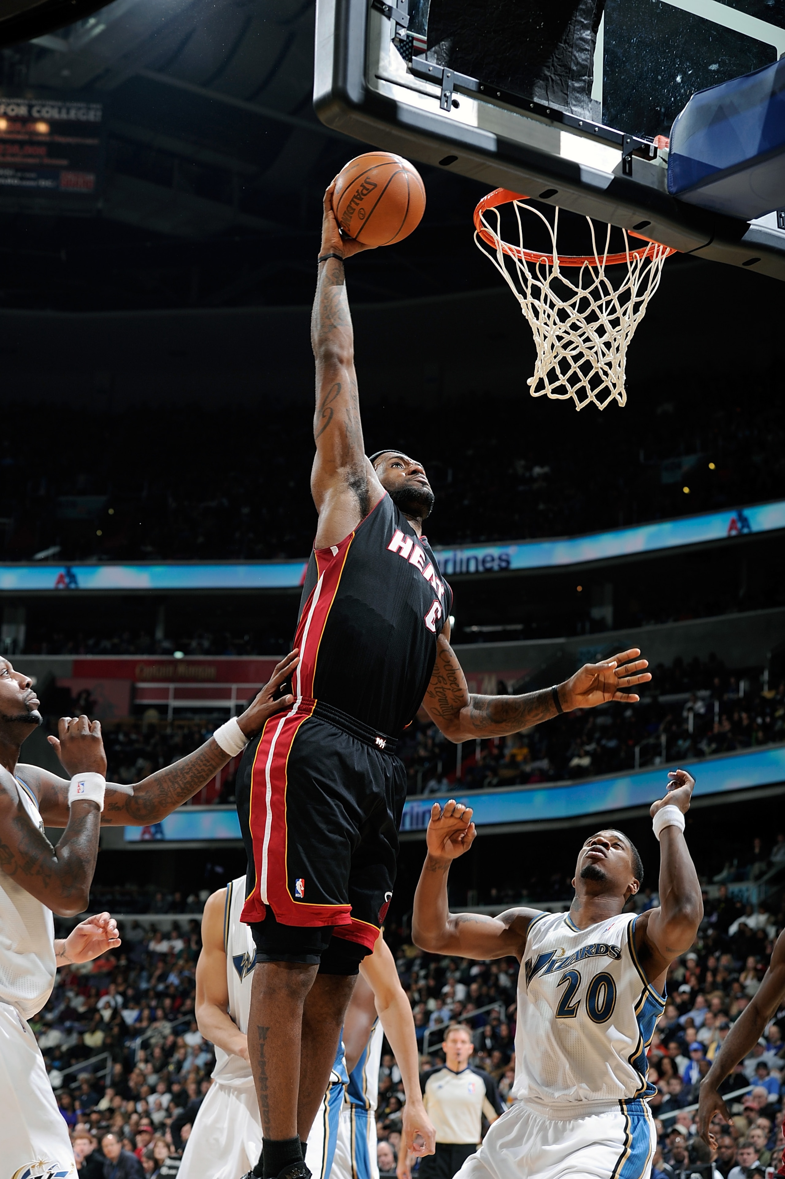 WASHINGTON - DECEMBER 18:  LeBron James #6 of the Miami Heat dunks the ball against Cartier Martin #20 of the Washington Wizards at the Verizon Center on December 18, 2010 in Washington, DC.  NOTE TO USER: User expressly acknowledges and agrees that, by d