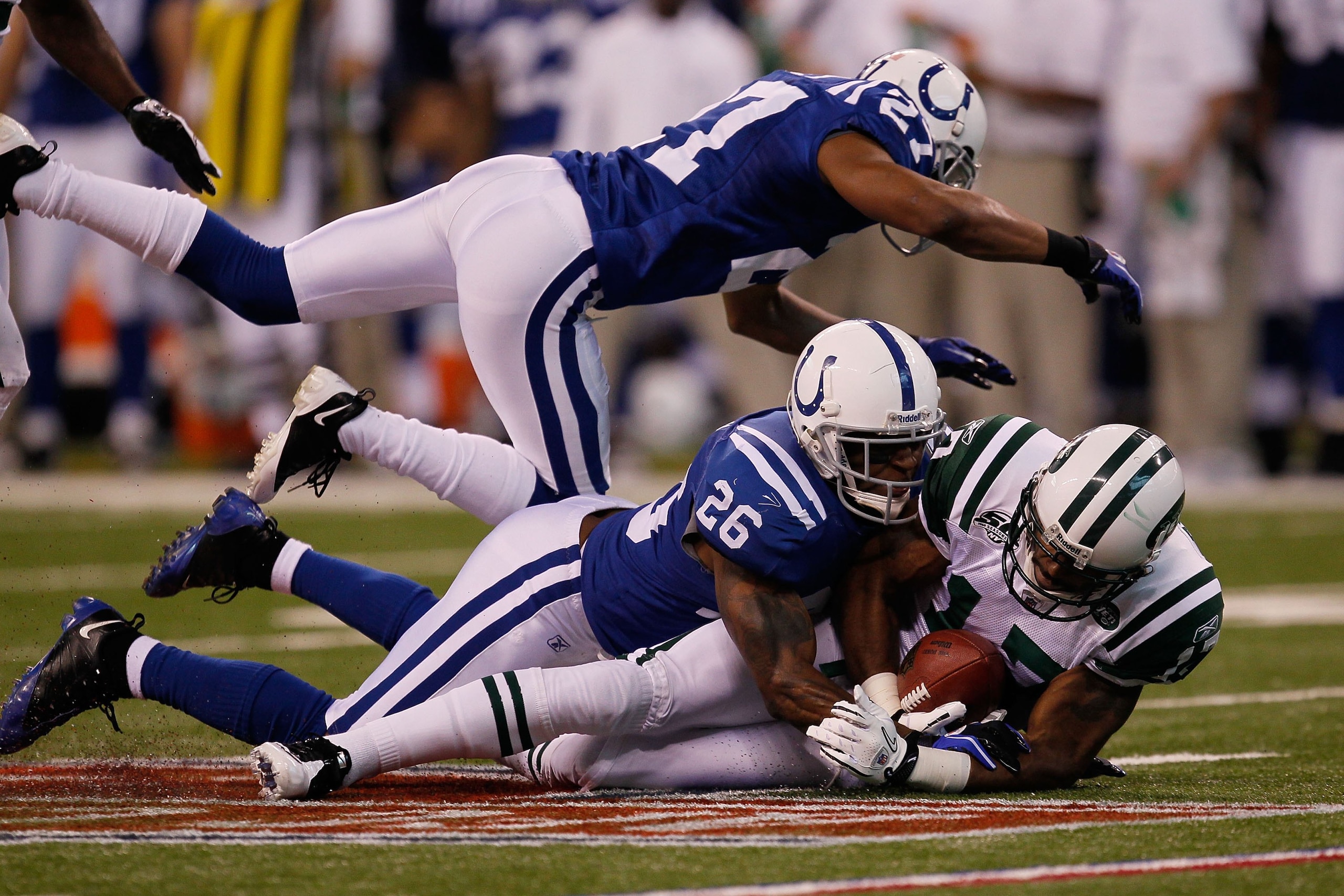 INDIANAPOLIS - JANUARY 24:  Wide receiver Braylon Edwards #17 of the New York Jets is tackled by Kelvin Hayden #26 of the Indianapolis Colts during the AFC Championship Game at Lucas Oil Stadium on January 24, 2010 in Indianapolis, Indiana.  (Photo by Jon