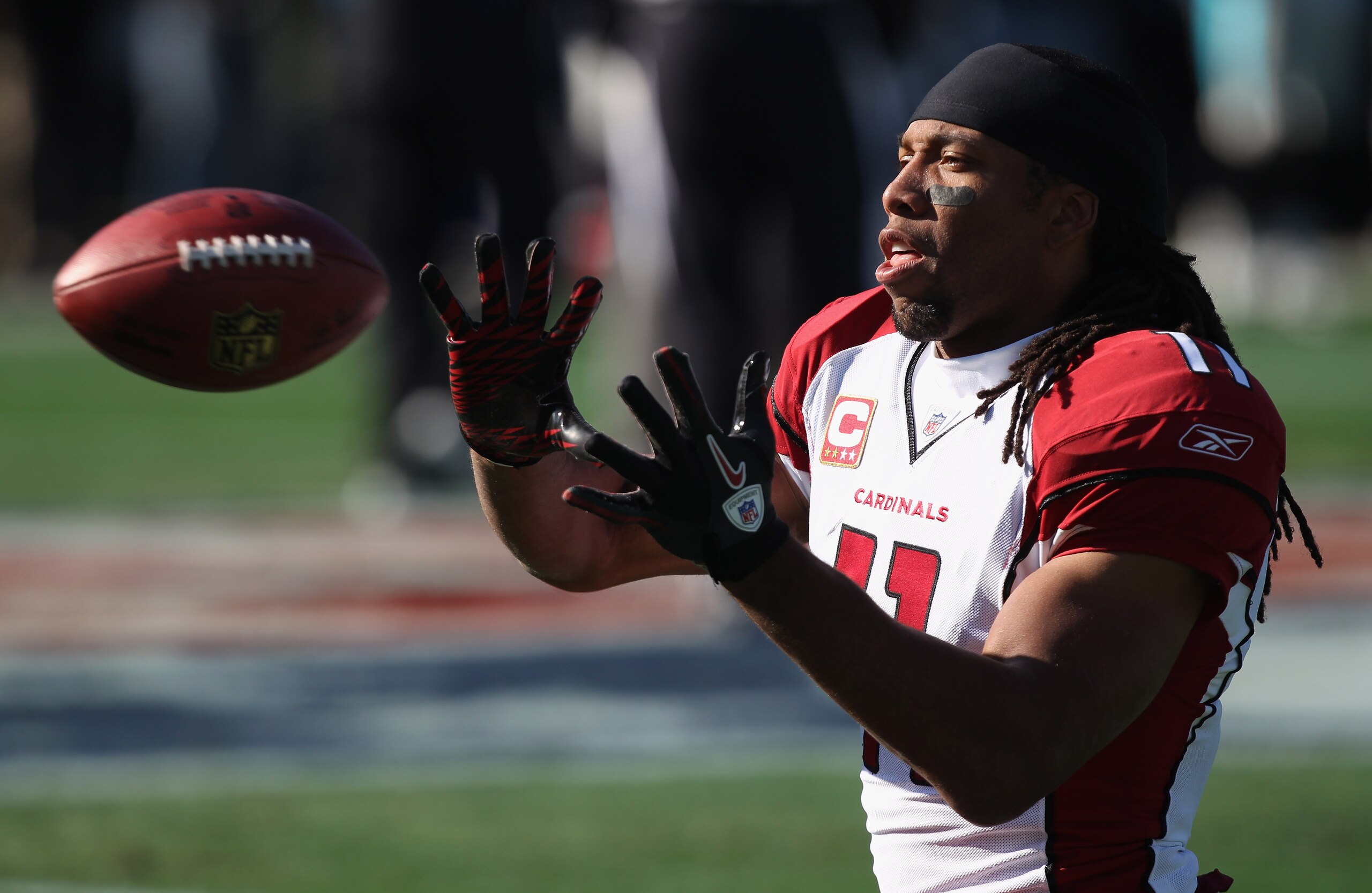 CHARLOTTE, NC - DECEMBER 19:  Larry Fitzgerald #11 of the Arizona Cardinals warms up before the start of their game against the Carolina Panthers at Bank of America Stadium on December 19, 2010 in Charlotte, North Carolina.  (Photo by Streeter Lecka/Getty
