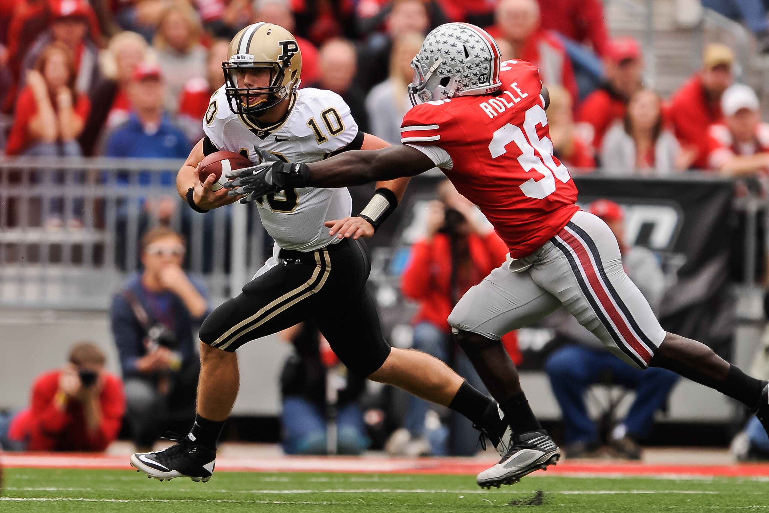 COLUMBUS, OH - OCTOBER 23:  Brian Rolle #36 of the Ohio State Buckeyes attempts to tackle Sean Robinson #10 of the Purdue Boilermakers at Ohio Stadium on October 23, 2010 in Columbus, Ohio.  (Photo by Jamie Sabau/Getty Images)