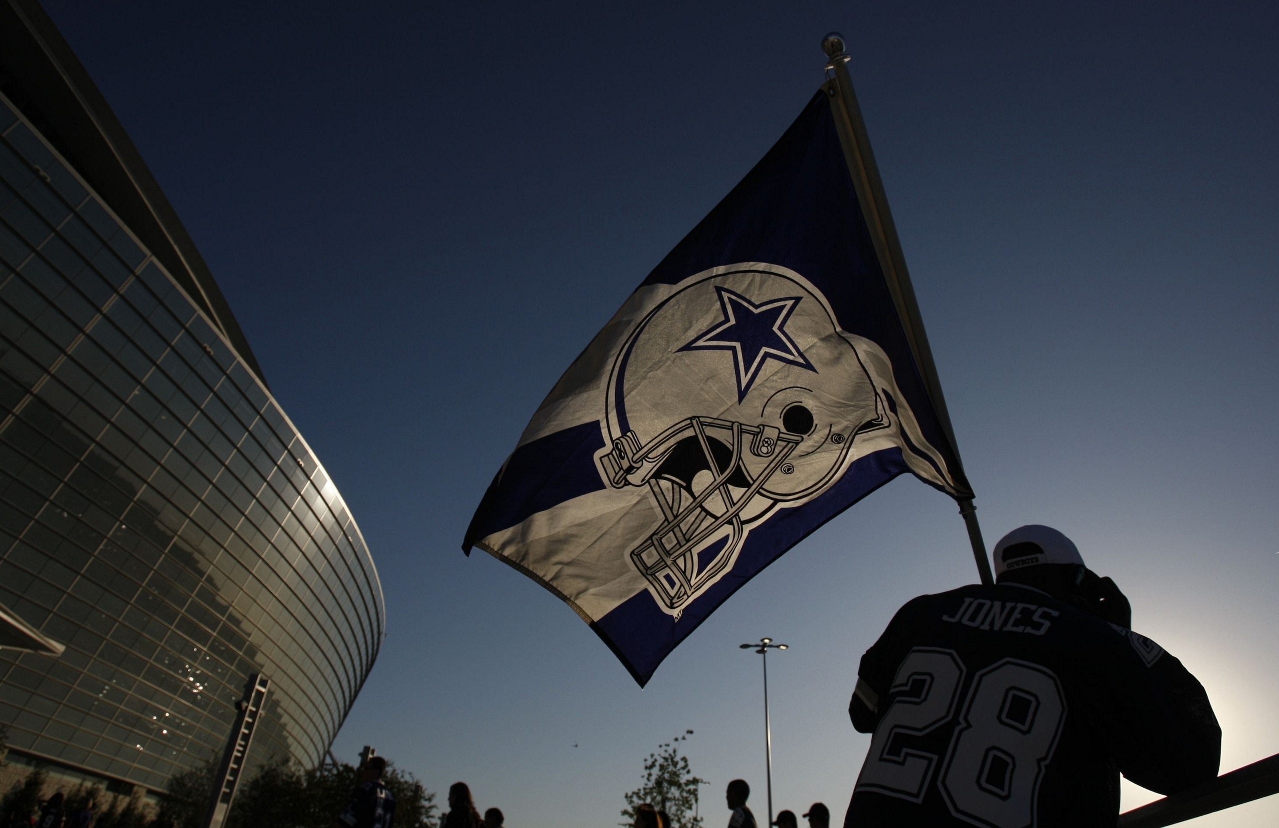 ARLINGTON, TX - SEPTEMBER 28: A fan holds a Dallas Cowboys flag outside of Cowboys Stadium prior to their game against the Carolina Panthers on September 28, 2009 in Arlington, Texas. (Photo by Ronald Martinez/Getty Images)