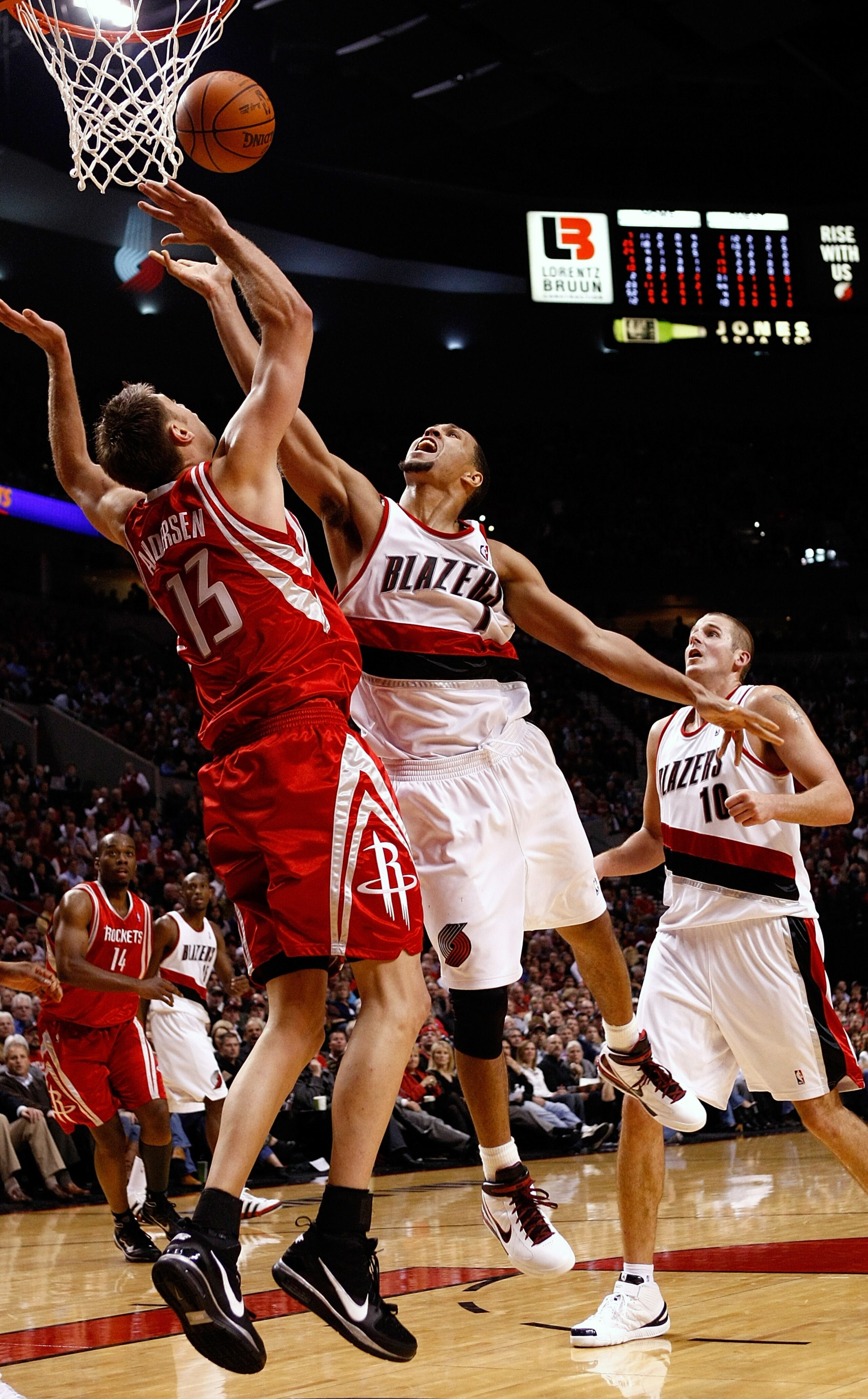 PORTLAND, OR - OCTOBER 27:  Brandon Roy #7 of the Portland Trail Blazers drives against David Andersen #13 of the Houston Rockets during the season opener on October 27, 2009 at the Rose Garden in Portland, Oregon. NOTE TO USER: User expressly acknowledge
