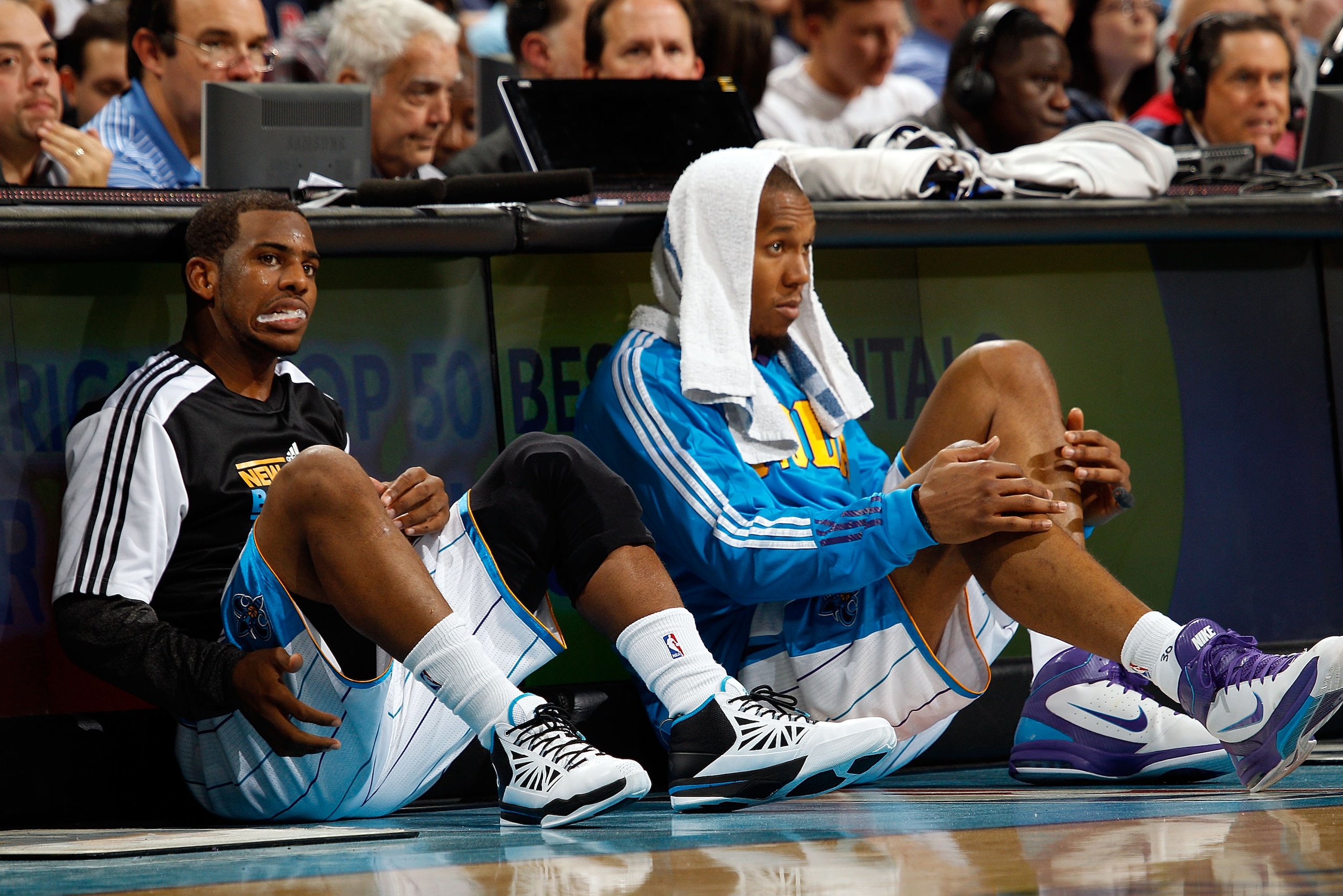 NEW ORLEANS, LA - DECEMBER 26:  Chris Paul #3 and David West #30 of the New Orleans Hornets sit on the floor before being substituted into the game while playing the Atlanta Hawks at the New Orleans Arena on December 26, 2010 in New Orleans, Louisiana.  N