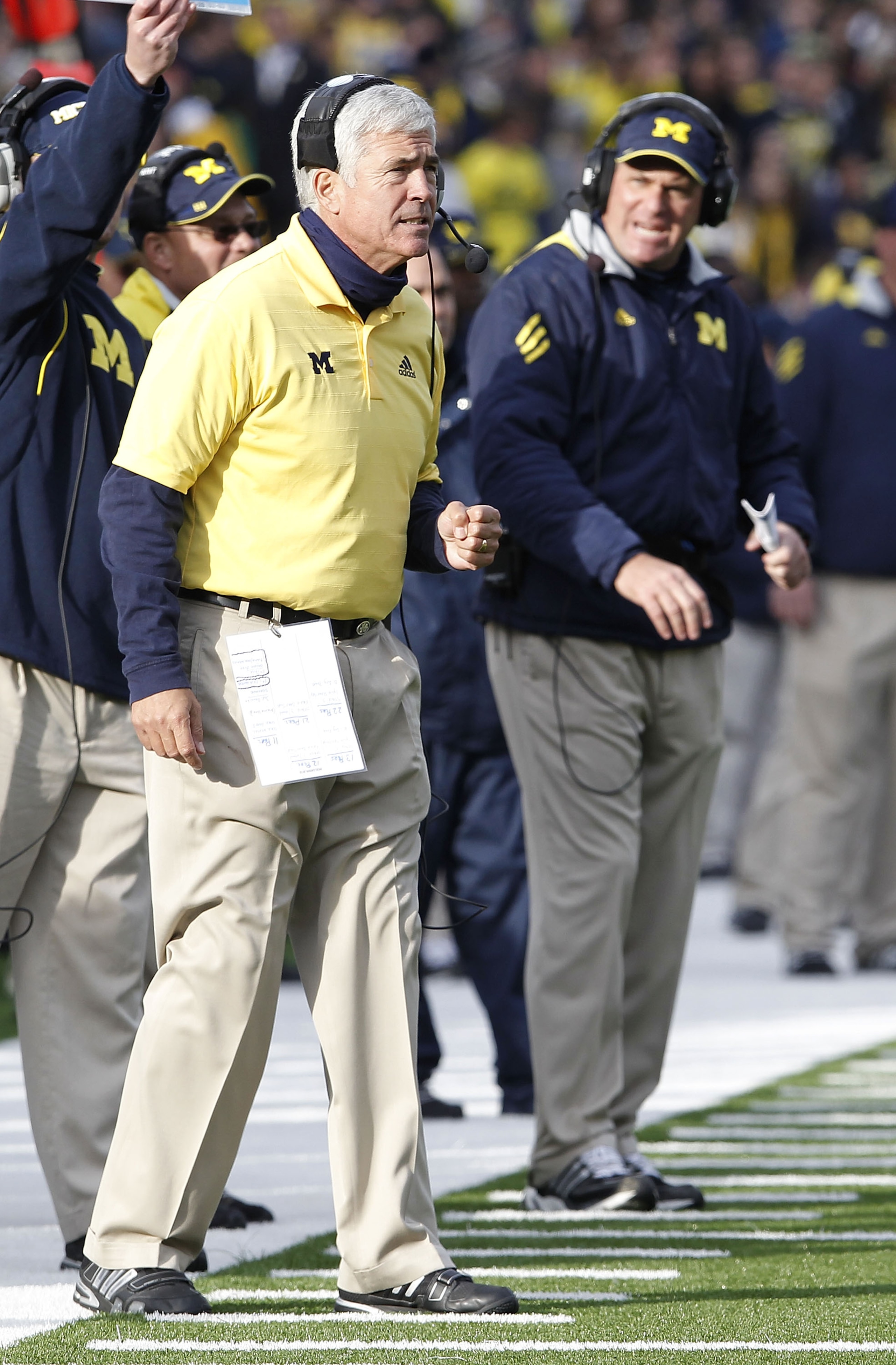 ANN ARBOR, MI - NOVEMBER 20: Defensive Cordinator Greg Robinson of the Michigan Wolverines reats with Head coach Rich Rodriguez looking on while playing the Wisconsin Badgers at Michigan Stadium on November 20, 2010 in Ann Arbor, Michigan. Wisconsin won ANN ARBOR, MI - NOVEMBER 20: Defensive Cordinator Greg Robinson of the Michigan Wolverines reats with Head coach Rich Rodriguez looking on while playing the Wisconsin Badgers at Michigan Stadium on November 20, 2010 in Ann Arbor, Michigan. Wisconsin won