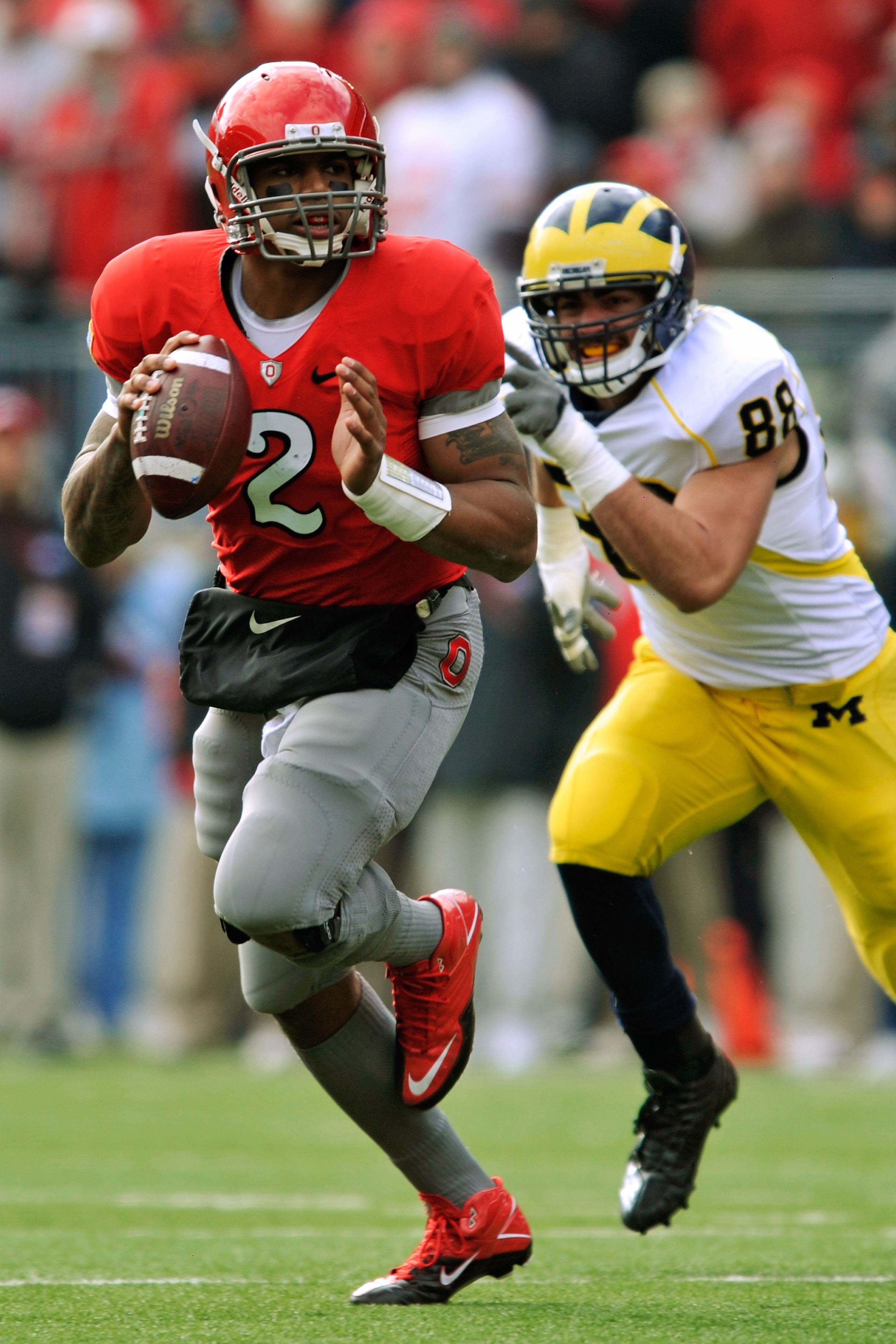 COLUMBUS, OH - NOVEMBER 27:  Quarterback Terrelle Pryor #2 of the Ohio State Buckeyes rolls out of the pocket looking for his receiver as Craig Roh #88 of the Michigan Wolverines pursues at Ohio Stadium on November 27, 2010 in Columbus, Ohio.  (Photo by J