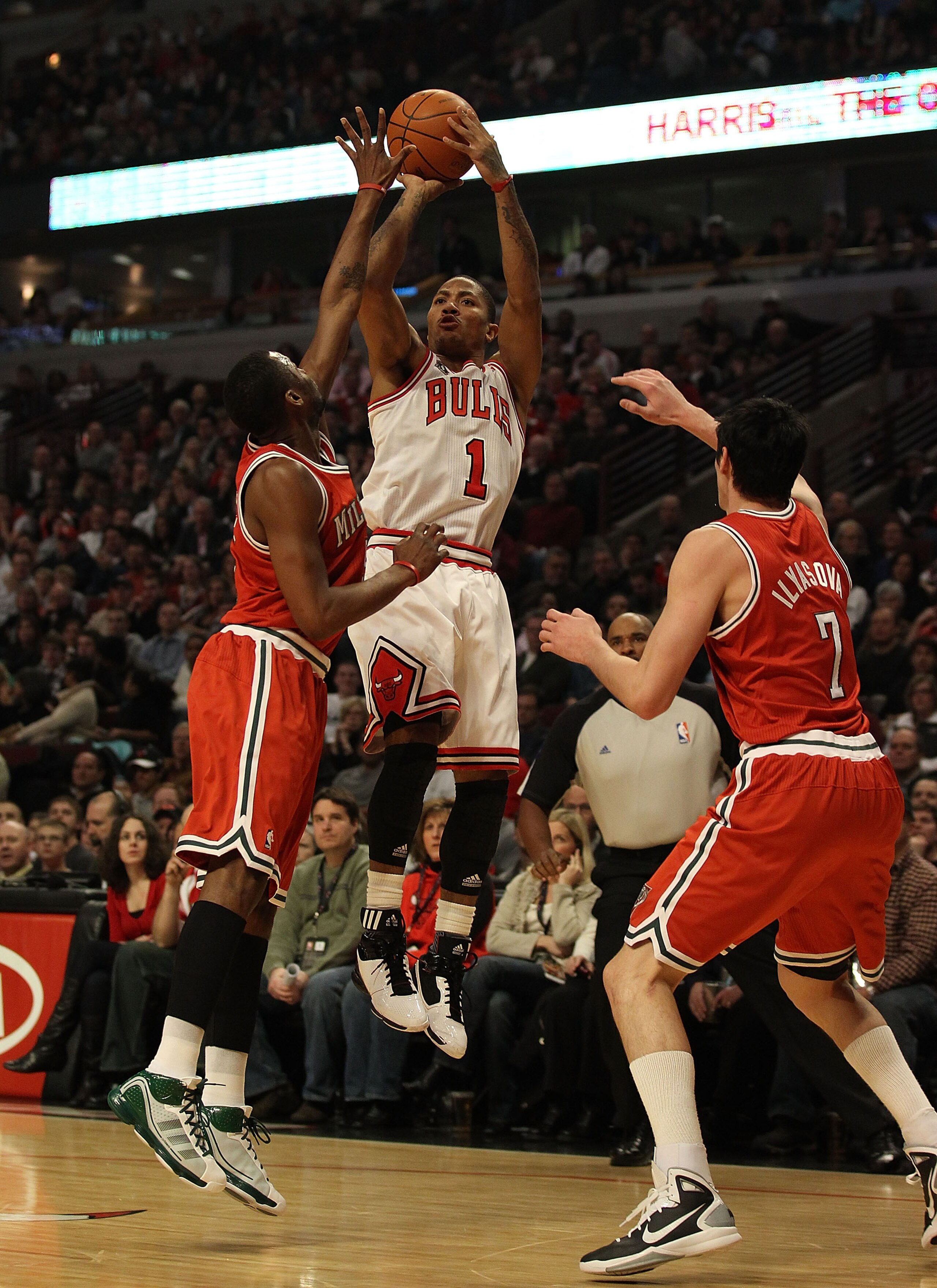 CHICAGO, IL - DECEMBER 28: Derrick Rose #1 of the Chicago Bulls puts up a shot against Keyon Dooling #55 and Ersan Ilyasova #7 of the Milwaukee Bucks at the United Center on December 28, 2010 in Chicago, Illinois. The Bulls defeated the Bucks 90-77. NOTE
