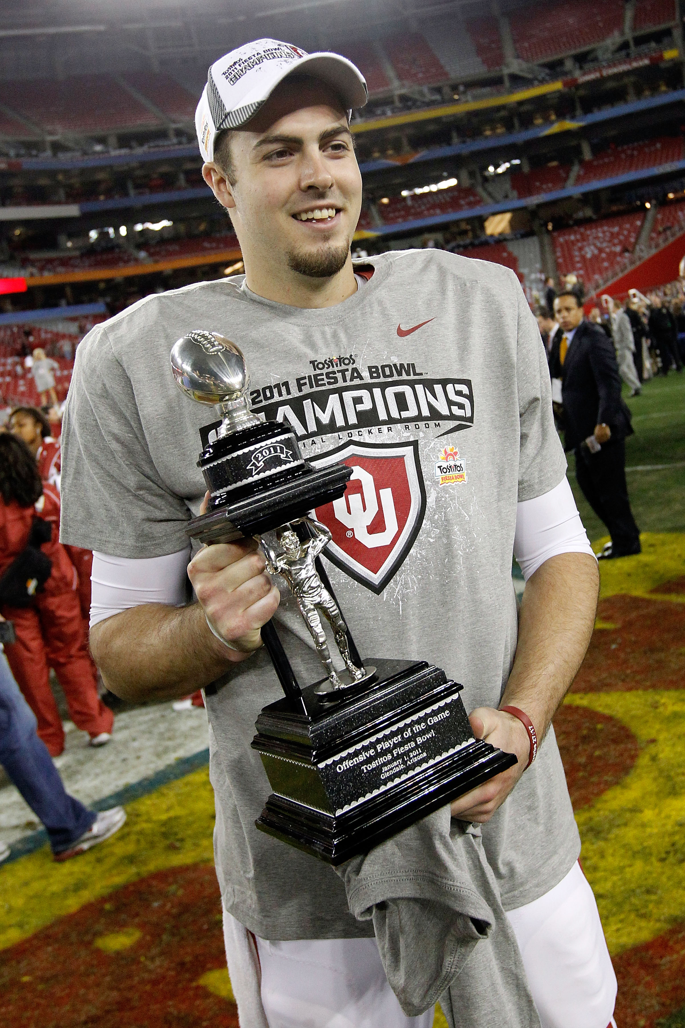 GLENDALE, AZ - JANUARY 01: Quarterback Landry Jones #12 of the Oklahoma Sooners and offensive MVP celebrates the Sooners 48-20 victory against the Connecticut Huskies during the Tostitos Fiesta Bowl at the Universtity of Phoenix Stadium on January 1, 201 GLENDALE, AZ - JANUARY 01: Quarterback Landry Jones #12 of the Oklahoma Sooners and offensive MVP celebrates the Sooners 48-20 victory against the Connecticut Huskies during the Tostitos Fiesta Bowl at the Universtity of Phoenix Stadium on January 1, 201