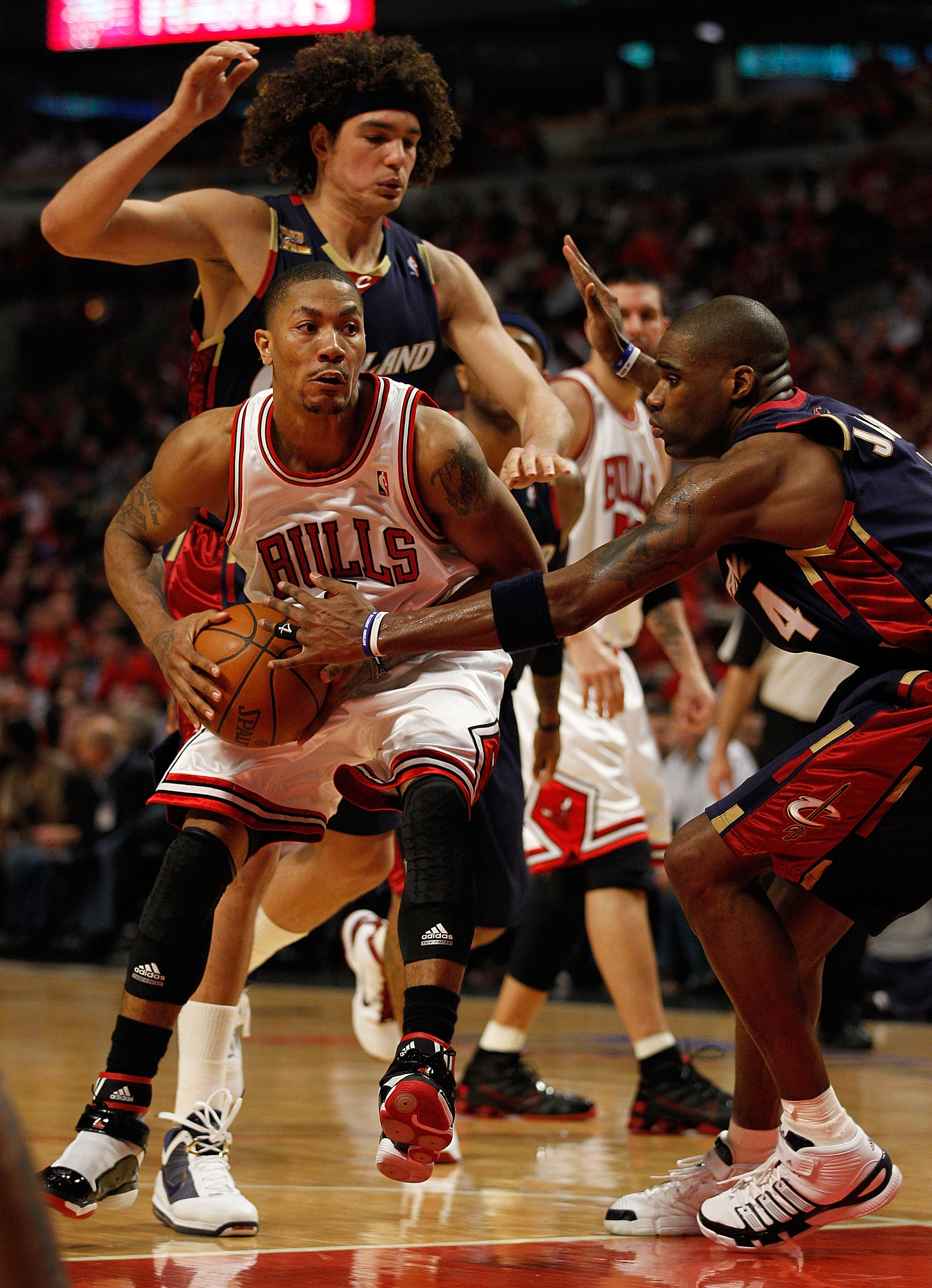 CHICAGO - APRIL 22: Derrick Rose #1 of the Chicago Bulls moves against Anderson Varejao #17 and Antawn Jamison #4 of the Cleveland Cavaliers in Game Three of the Eastern Conference Quarterfinals during the 2010 NBA Playoffs at the United Center on April 2