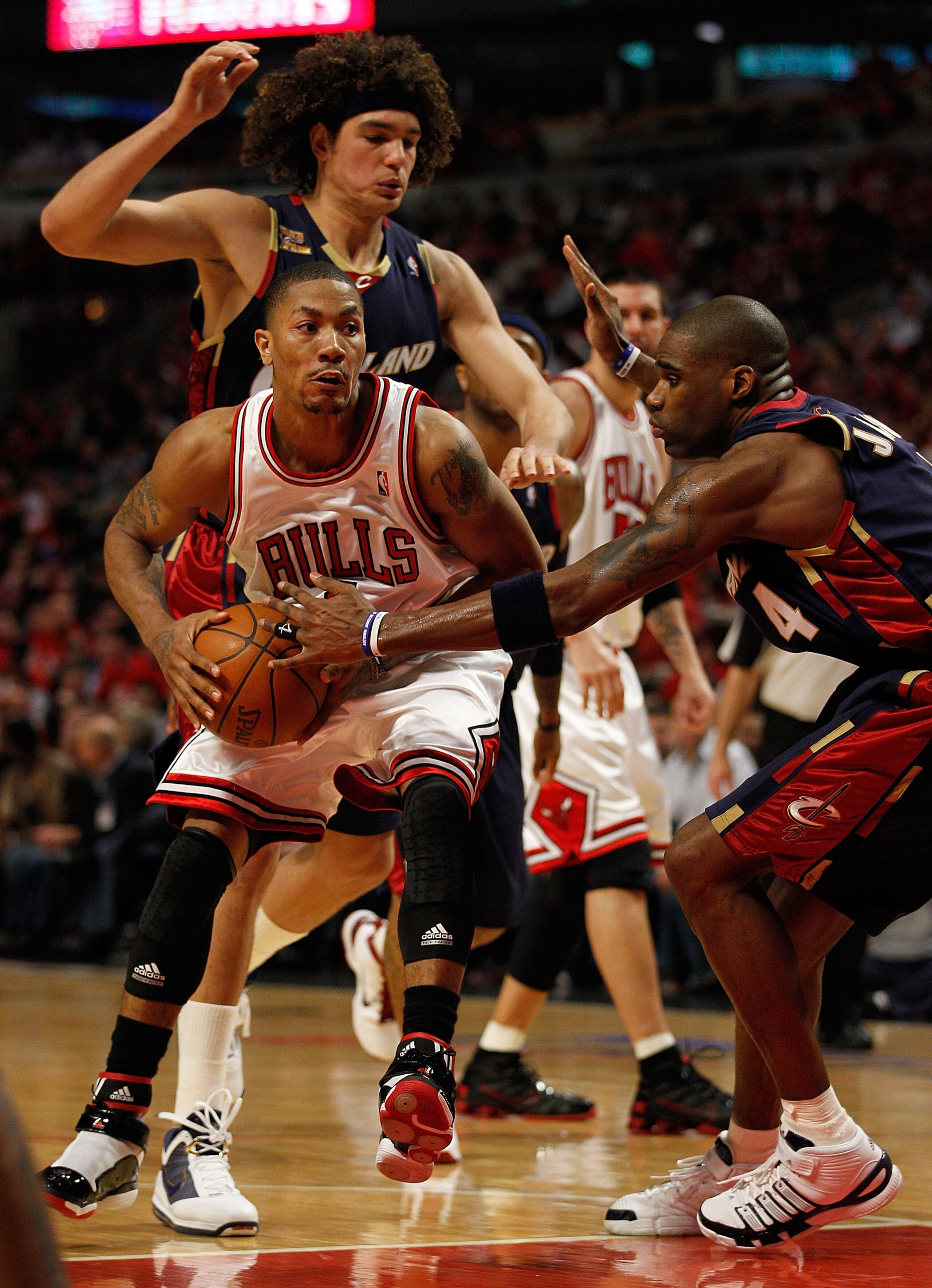 CHICAGO - APRIL 22: Derrick Rose #1 of the Chicago Bulls moves against Anderson Varejao #17 and Antawn Jamison #4 of the Cleveland Cavaliers in Game Three of the Eastern Conference Quarterfinals during the 2010 NBA Playoffs at the United Center on April 2