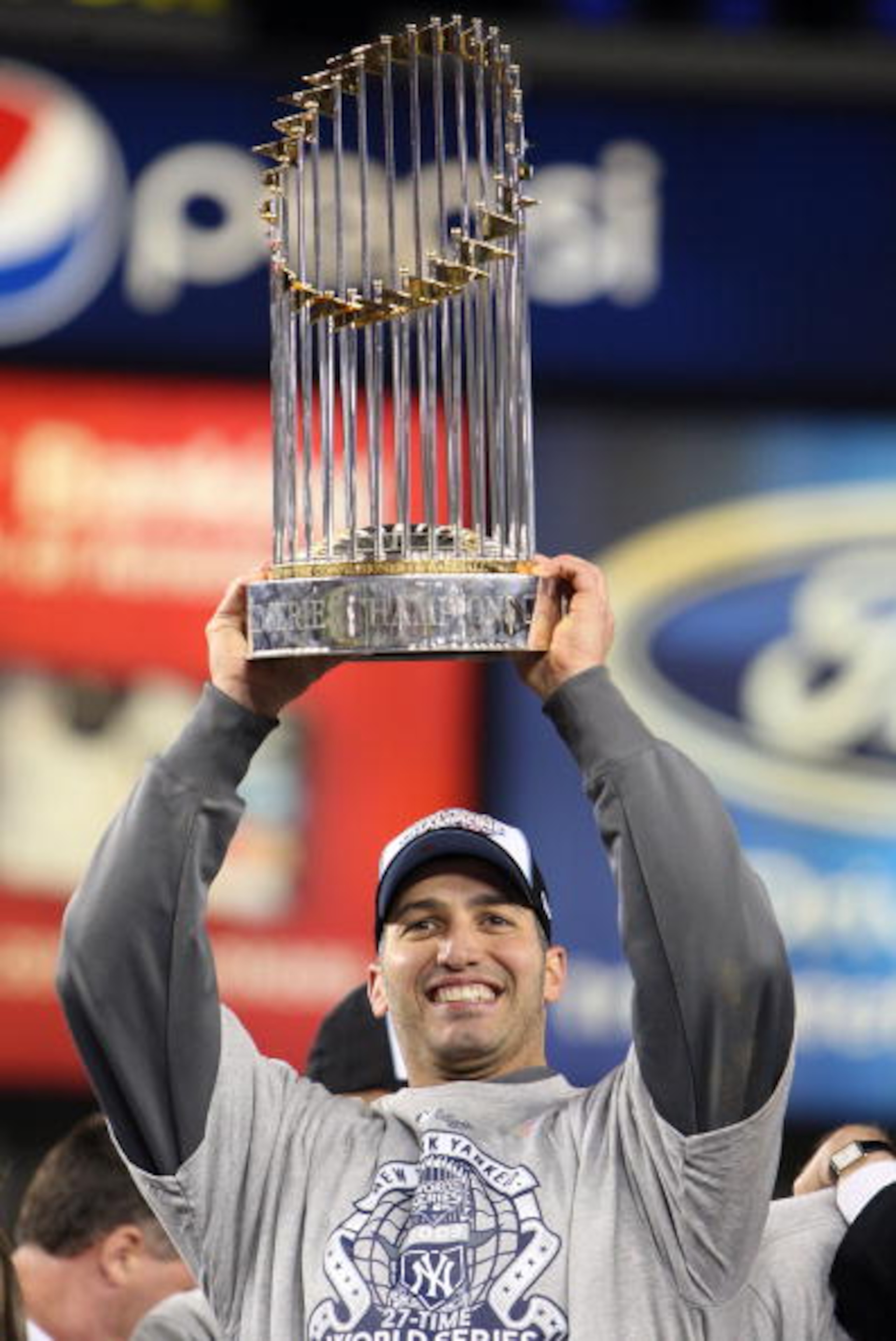 NEW YORK - NOVEMBER 04:  Andy Pettitte #46 of the New York Yankees celebrates with the trophy after their 7-3 win against the Philadelphia Phillies in Game Six of the 2009 MLB World Series at Yankee Stadium on November 4, 2009 in the Bronx borough of New