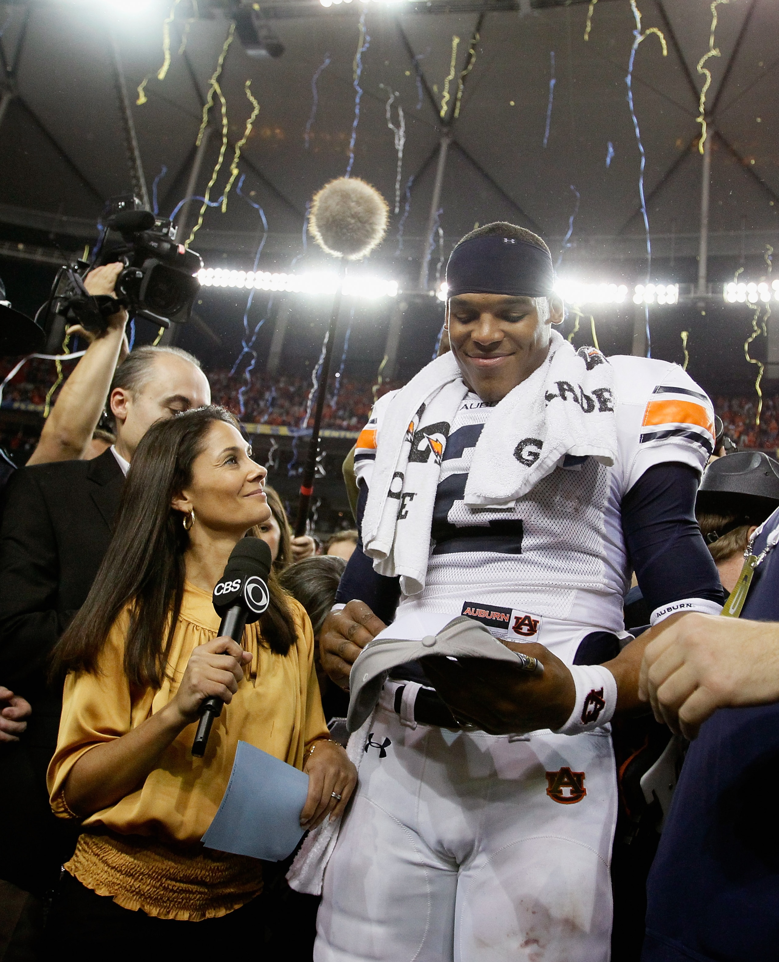 ATLANTA, GA - DECEMBER 04:  CBS sideline reporter Tracy Wolfson waits for an interview as quarterback Cam Newton #2 of the Auburn Tigers celebrates after their 56-17 win over the South Carolina Gamecocks during the 2010 SEC Championship at Georgia Dome on