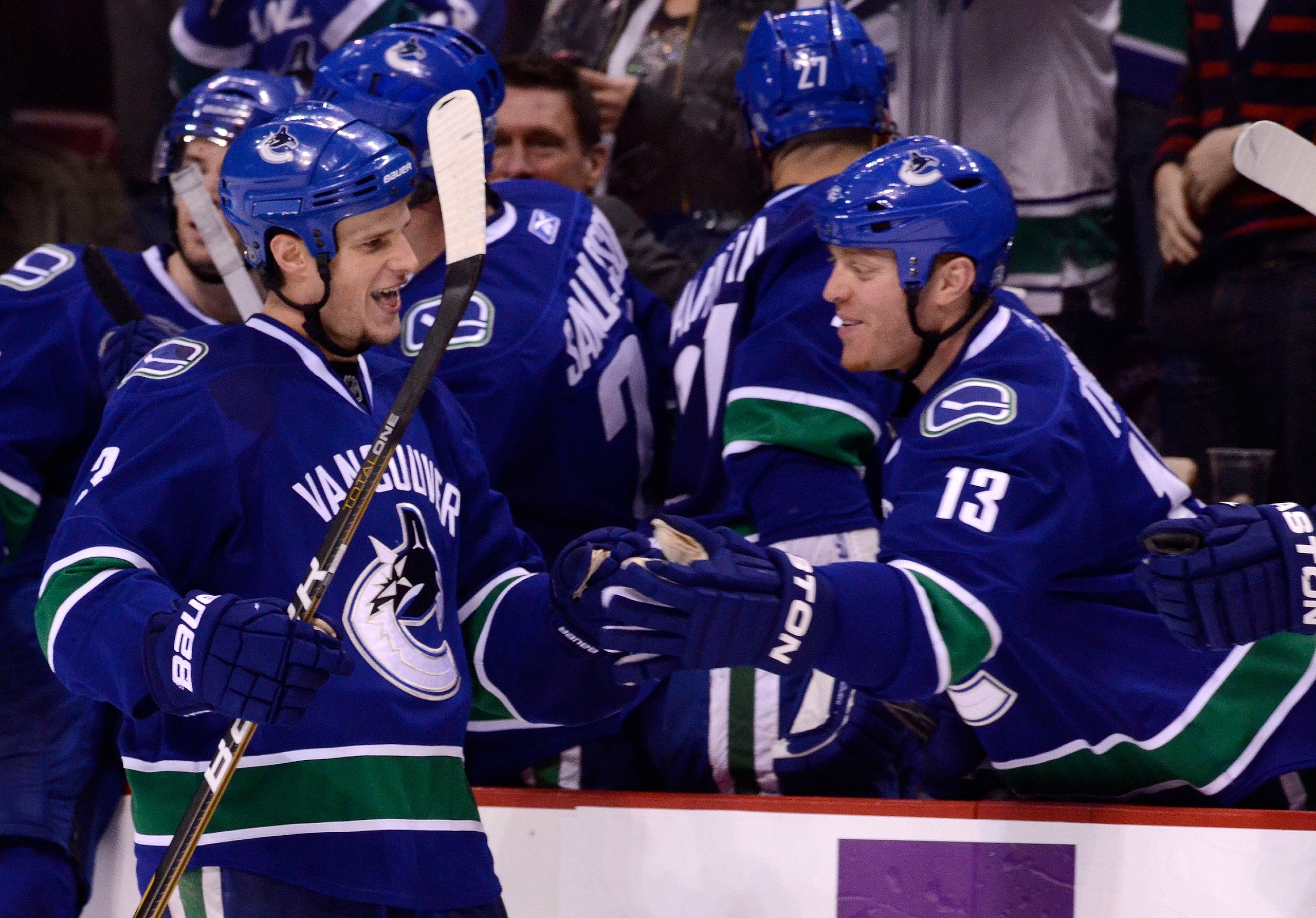 VANCOUVER, CANADA - DECEMBER 26: Kevin Bieksa #3 of the Vancouver Canucks is congratulated by Raffi Torres #13 after scoring what proved to be the game winning goal in a 3-2 win against the Edmonton Oilers during the third period in NHL action on December