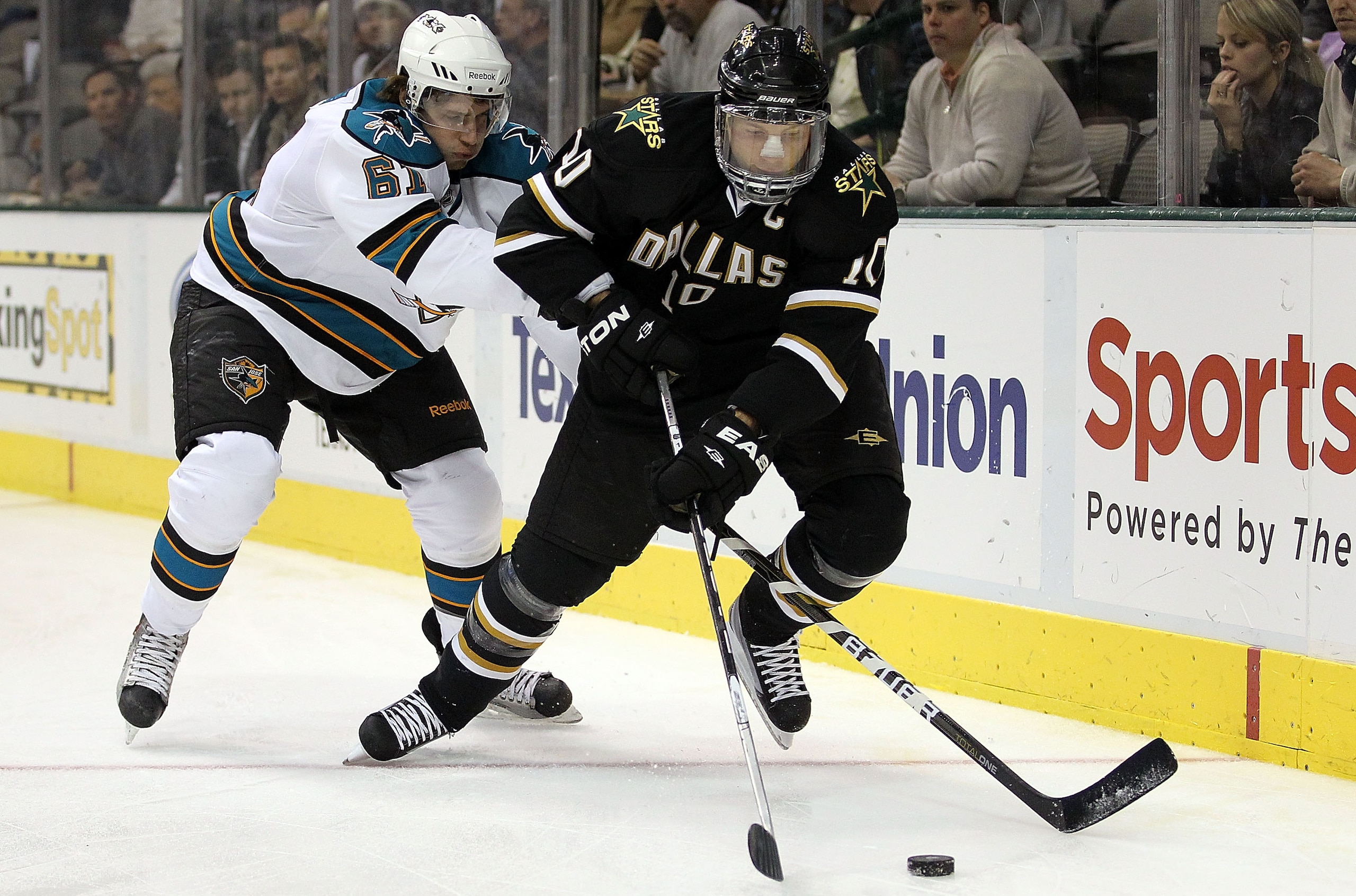 DALLAS, TX - DECEMBER 16:  Left wing Brenden Morrow #10 of the Dallas Stars skates the puck past Justin Braun #61 of the San Jose Sharks at American Airlines Center on December 16, 2010 in Dallas, Texas.  (Photo by Ronald Martinez/Getty Images)