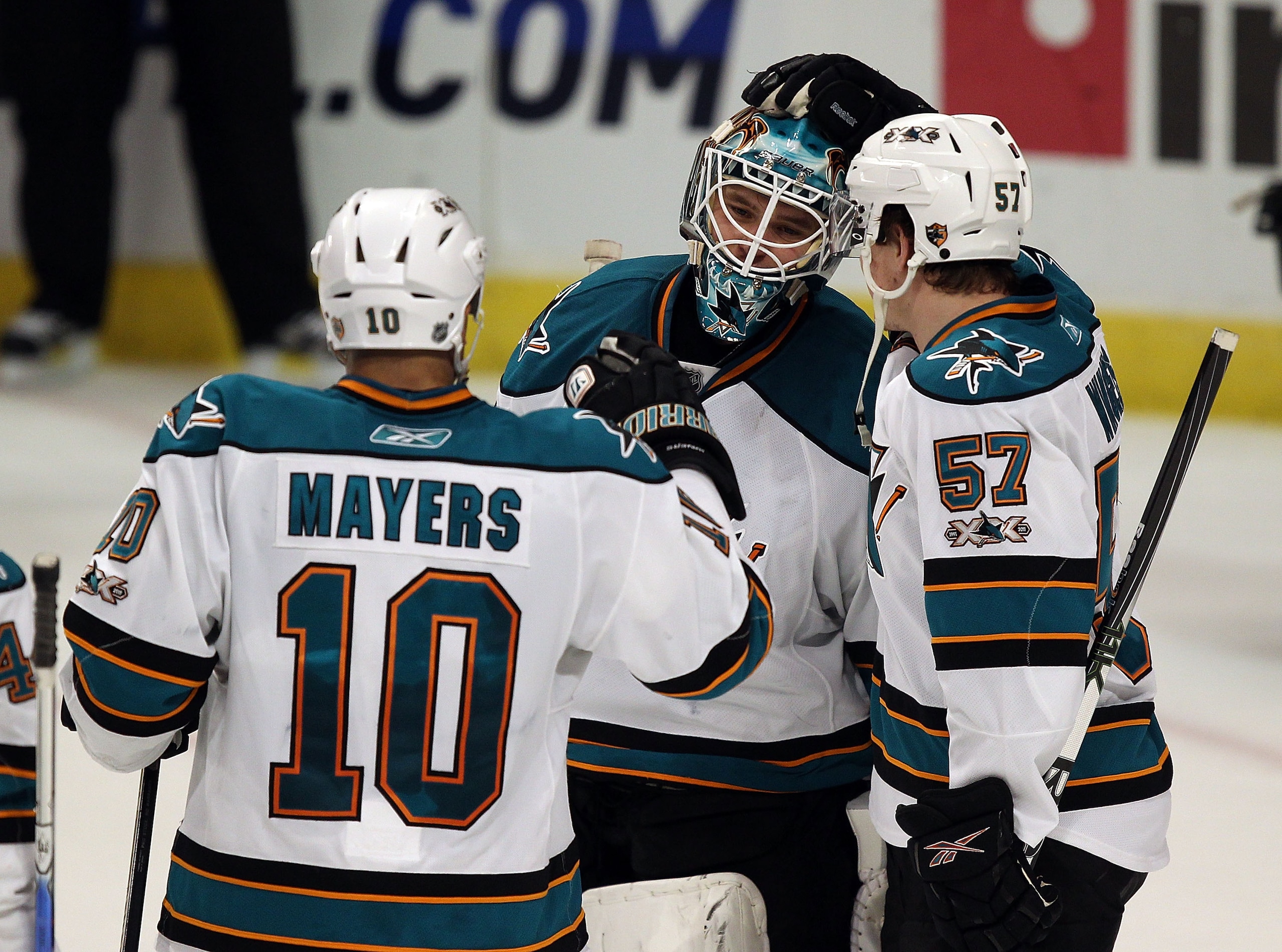 CHICAGO, IL - DECEMBER 30: Antti Niemi #31 of the San Jose Sharks is congratulated by teammates Jamal Mayers #10 and Tommy Wingels #57 after a win over the Chicago Blackhawks at the United Center on December 30, 2010 in Chicago, Illinois. The Sharks defea