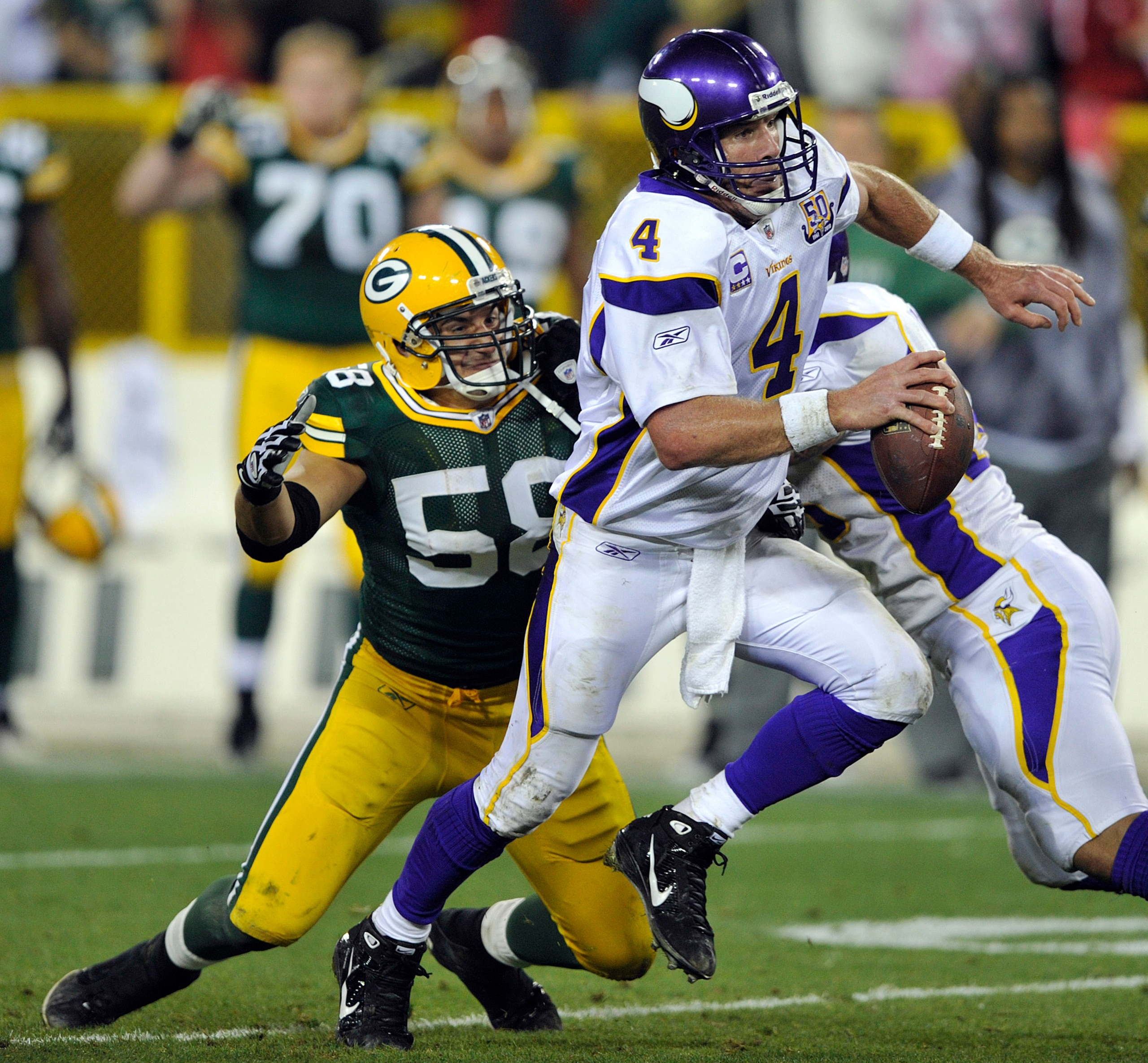 GREEN BAY, WI - OCTOBER 24:  Brett Favre #4 of the Minnesota Vikings scrambles away from Frank Zombo #58 of the Green Bay Packers at Lambeau Field on October 24, 2010 in Green Bay, Wisconsin.  The Packers defeated the Vikings 28-24. (Photo by Jim Prischin