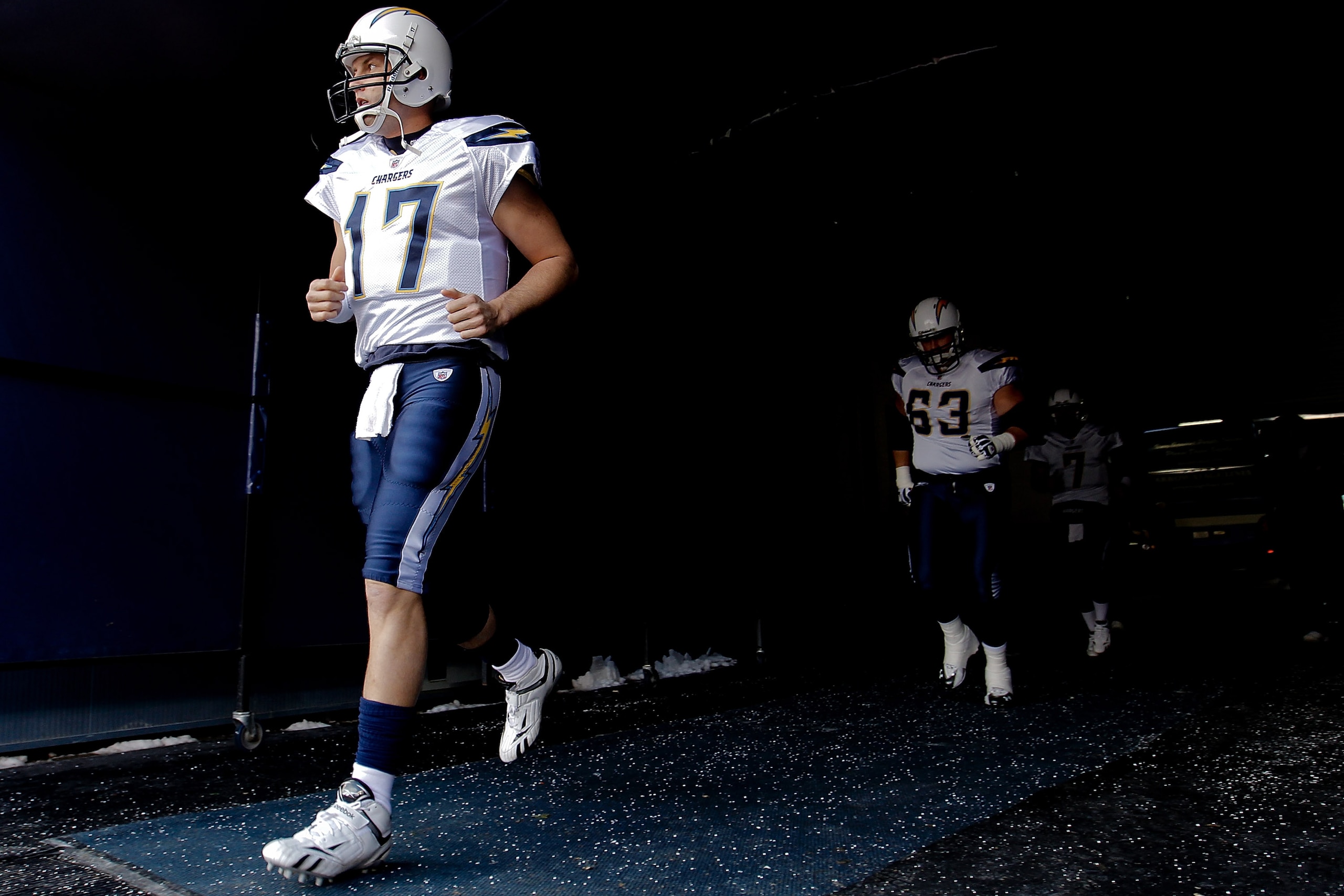 DENVER, CO - JANUARY 2:  Quarterback Philip Rivers #17 of the San Diego Chargers leads teammates center Scott Mruczkowski #63 and quarterback Billy Volek #7 out of the tunnel before a game against the Denver Broncos at INVESCO Field at Mile High on Januar