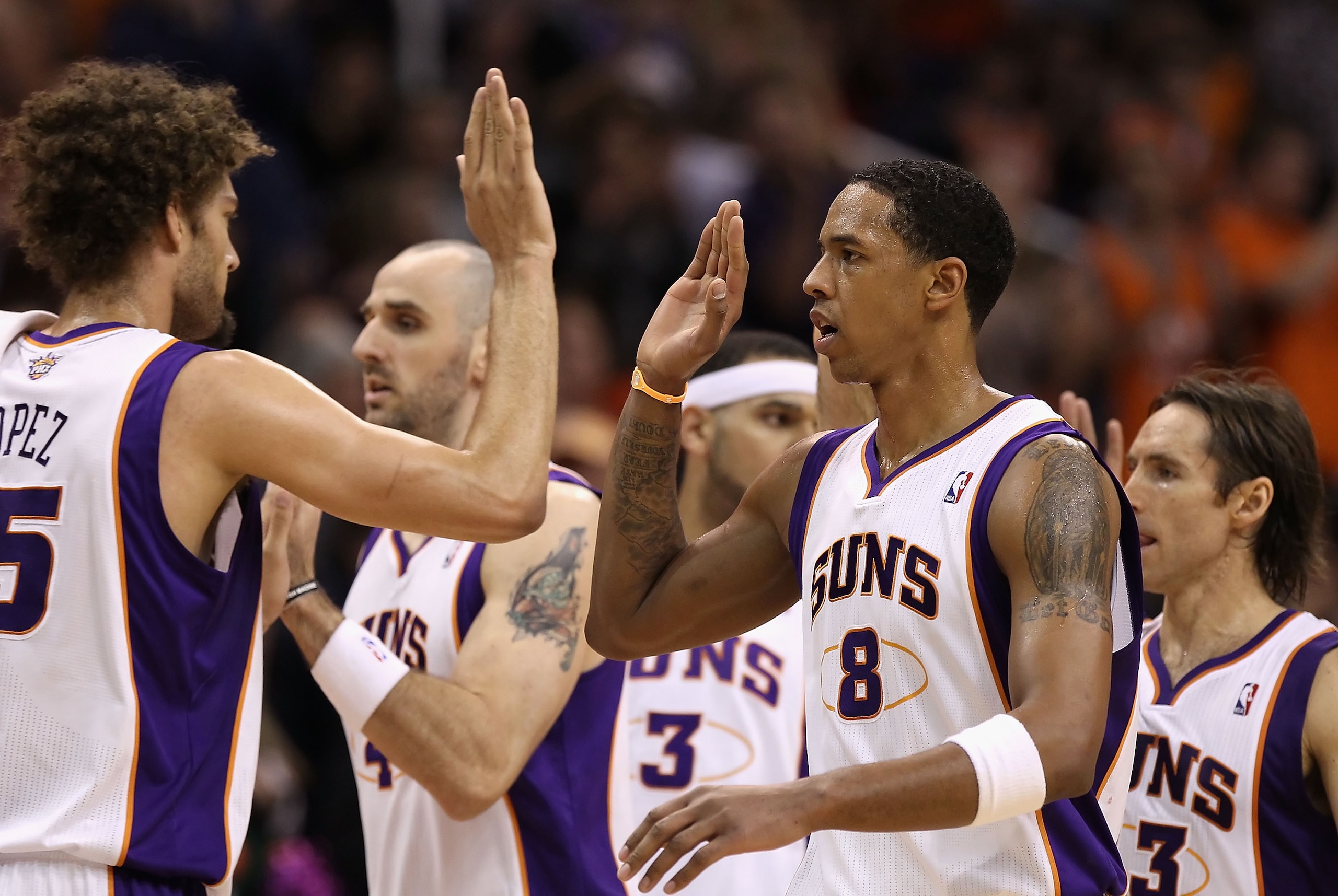 PHOENIX - DECEMBER 23:  Channing Frye #8 of the Phoenix Suns high fives teammates during the NBA game against the Miami Heat at US Airways Center on December 23, 2010 in Phoenix, Arizona.  The Heat defeated the Suns 95-83.  NOTE TO USER: User expressly ac
