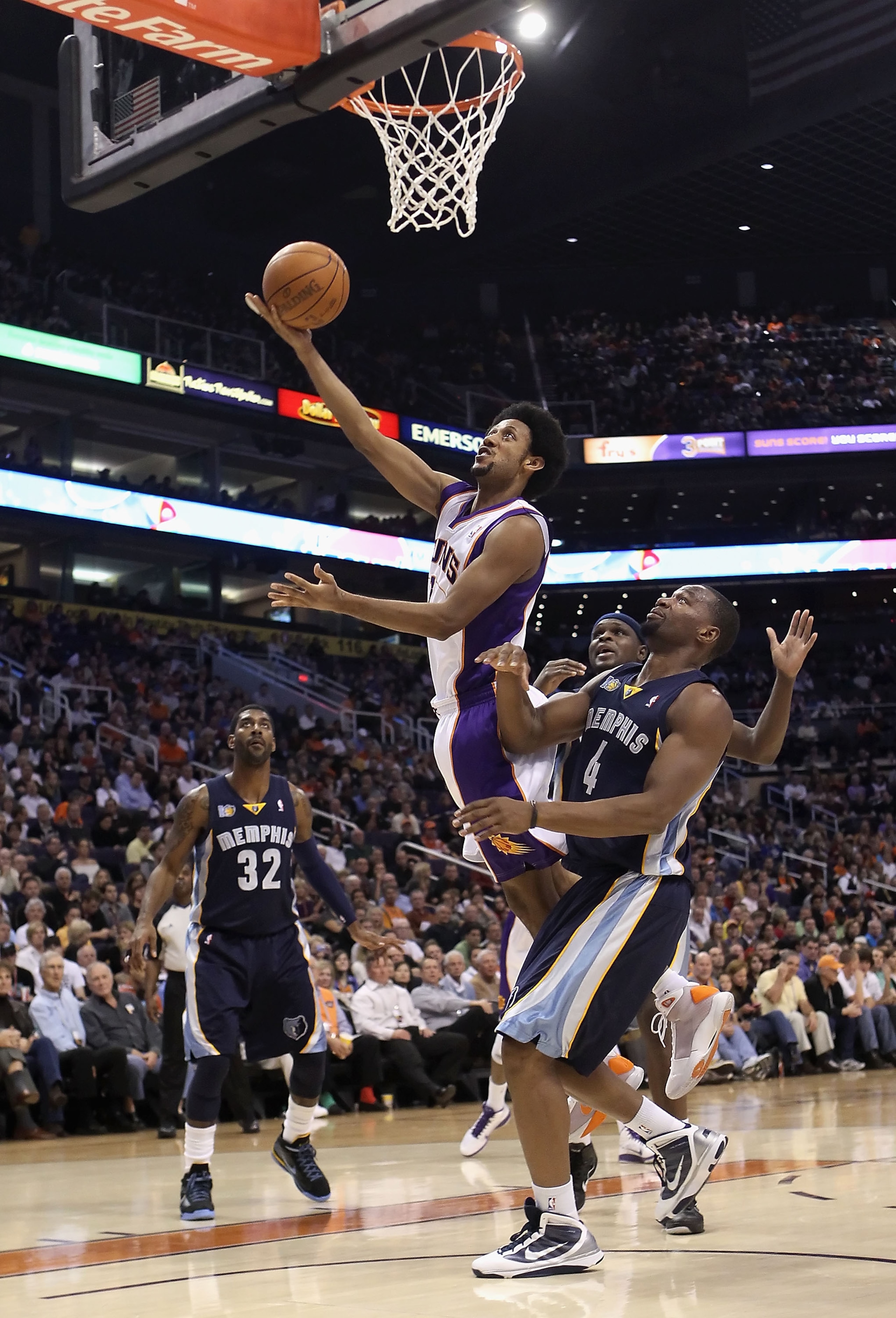 PHOENIX - DECEMBER 08:  Josh Childress #1 of the Phoenix Suns lays up a shot over Sam Young #4 of the Memphis Grizzlies during the NBA game at US Airways Center on December 8, 2010 in Phoenix, Arizona. NOTE TO USER: User expressly acknowledges and agrees